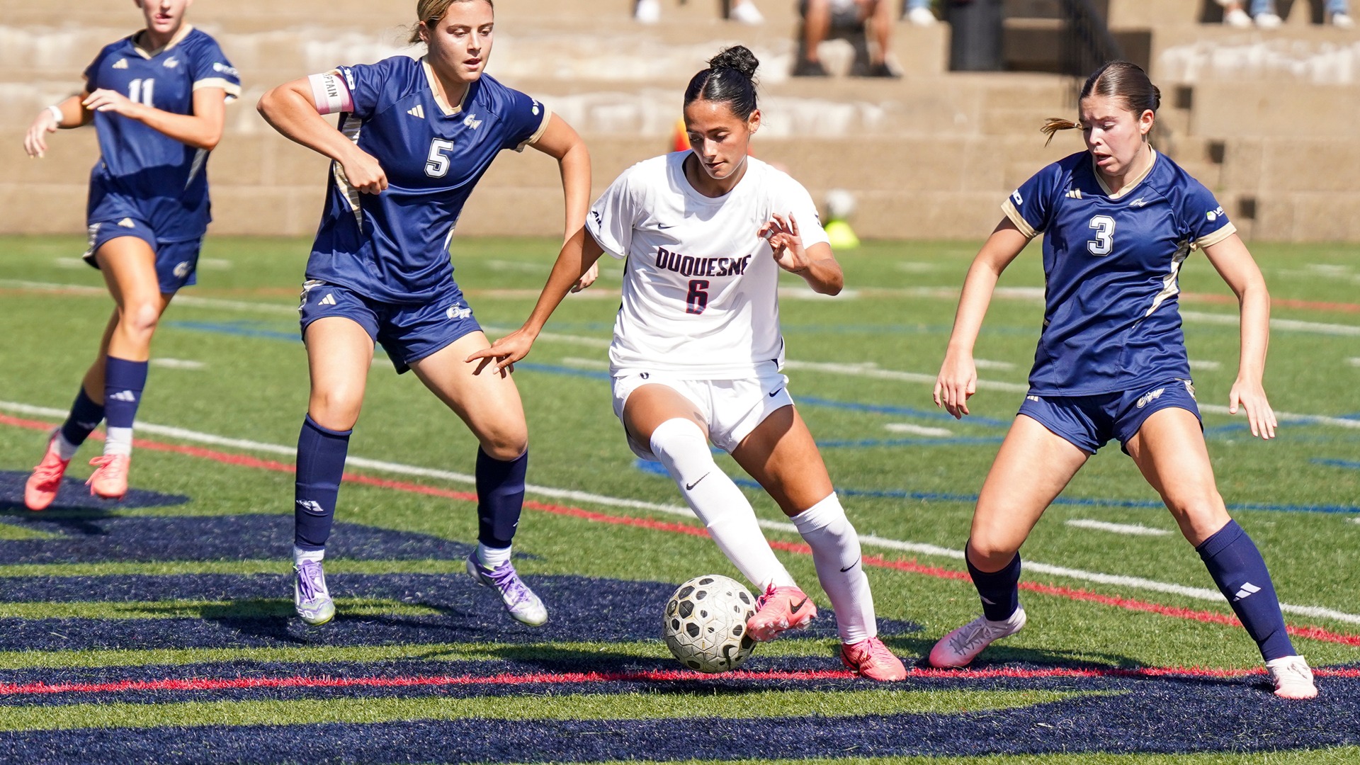 Kayla Leseck looks for space against GW Sunday at Rooney Field.