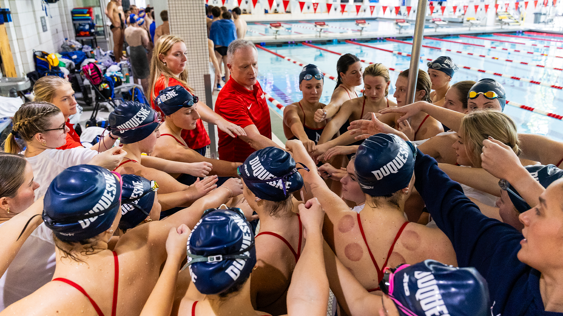 DUQ swim huddle at CMU Relays