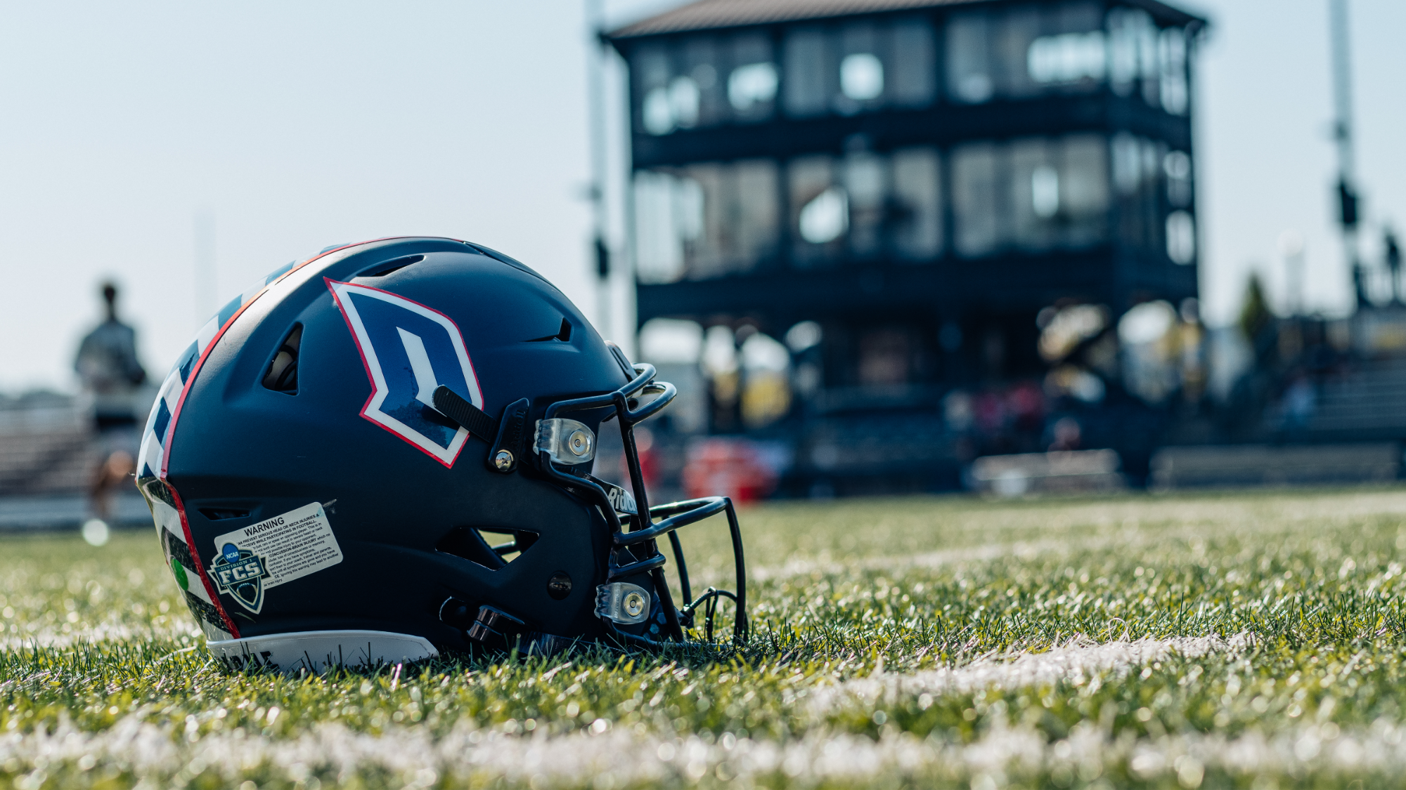 duquesne football helmet on rooney field turf before Lehigh game 2025