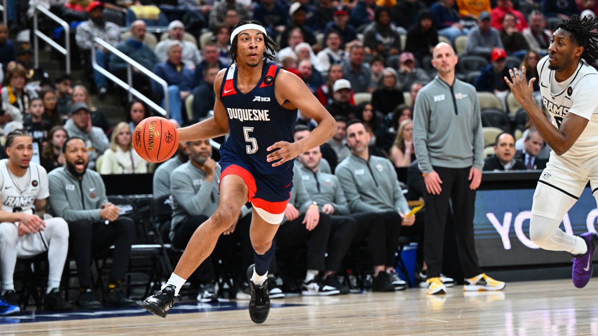 Cam Crawford dribbles vs. VCU at PPG Paints Arena.