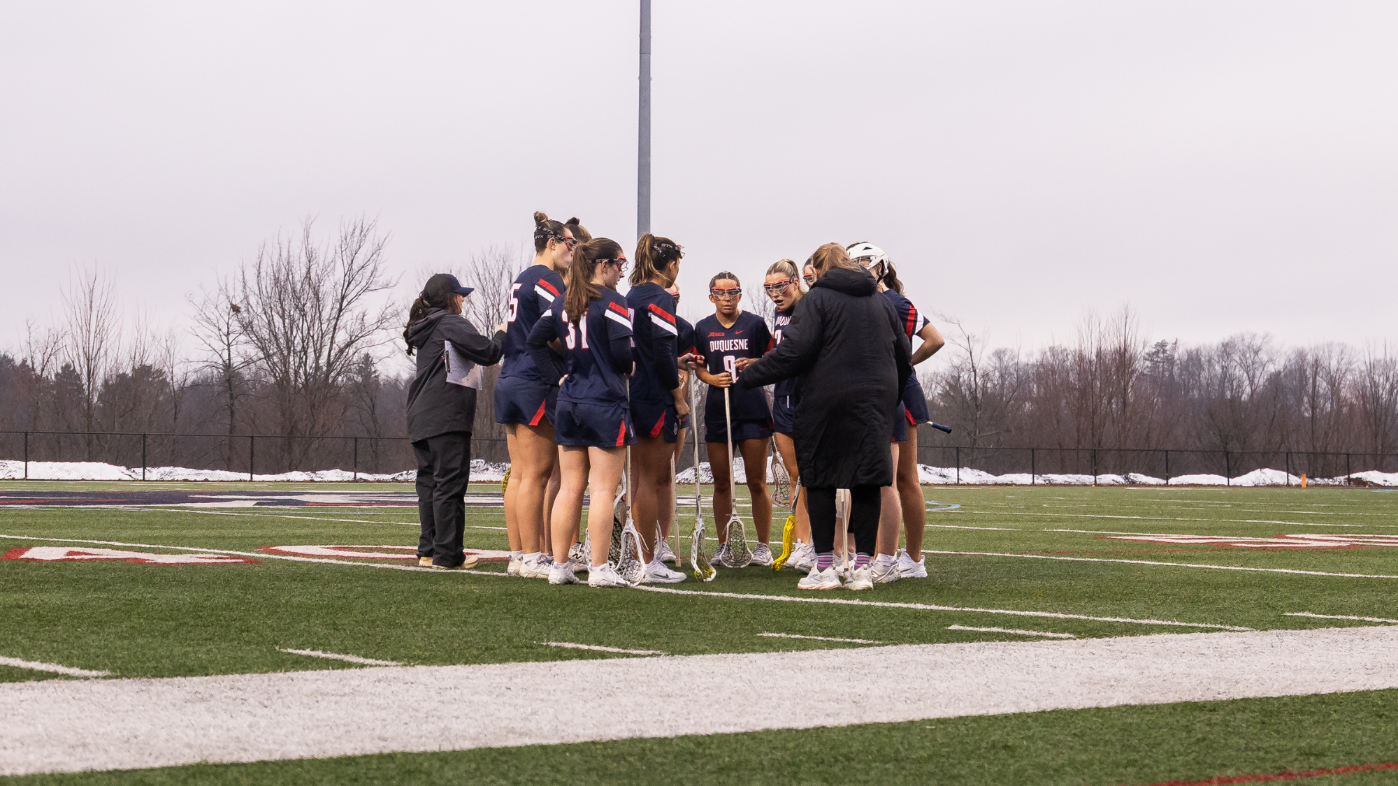 lacrosse huddle with coaches and players at rmu 2026