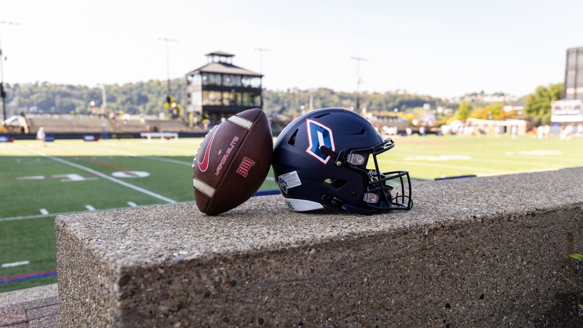 DUQ Football and helmet at Rooney Field
