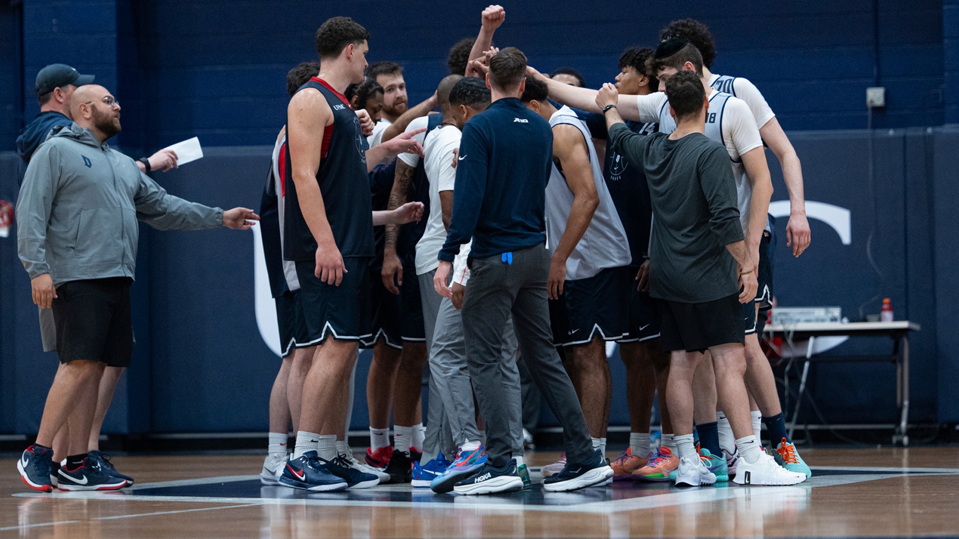 Men's basketball huddle before practice.