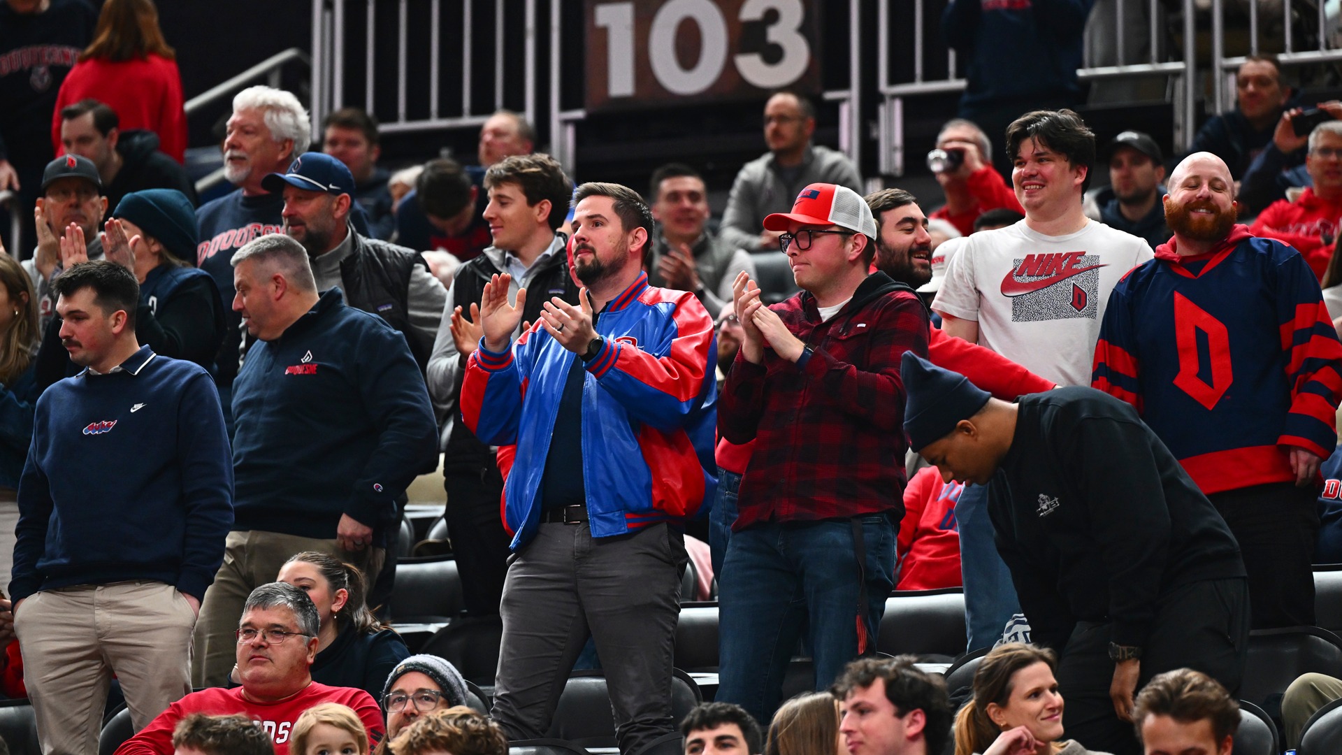 Duquesne basketball fans in stands at PPG Paints Arena.
