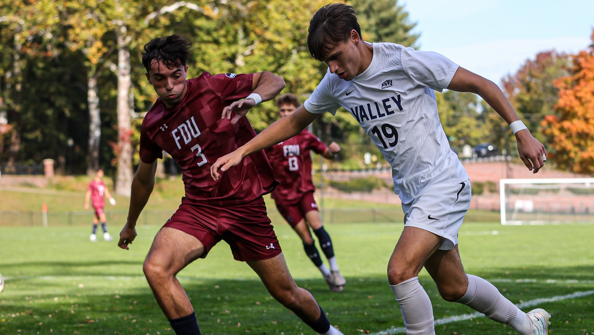 Will Burton taking the ball past a defender