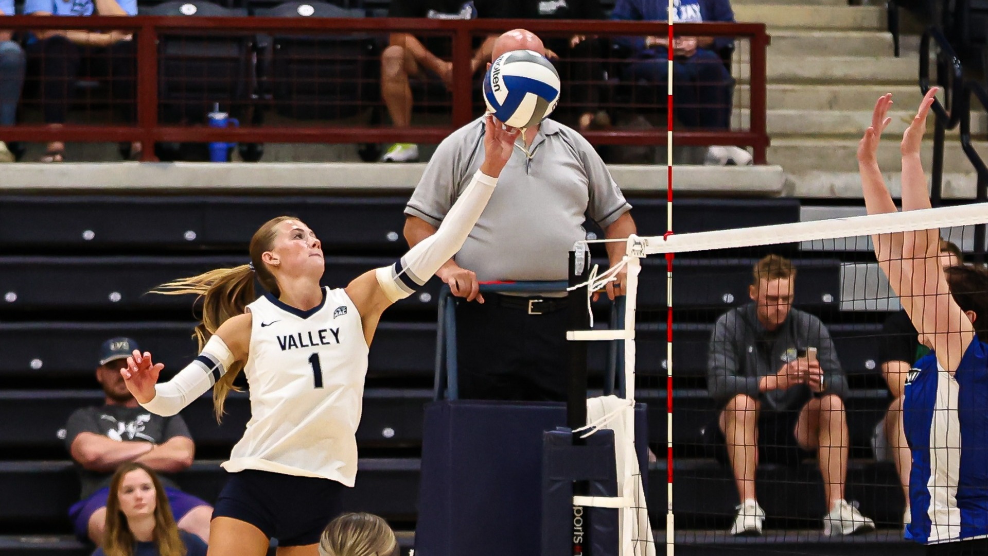 Mattea Penner knocking ball over the net