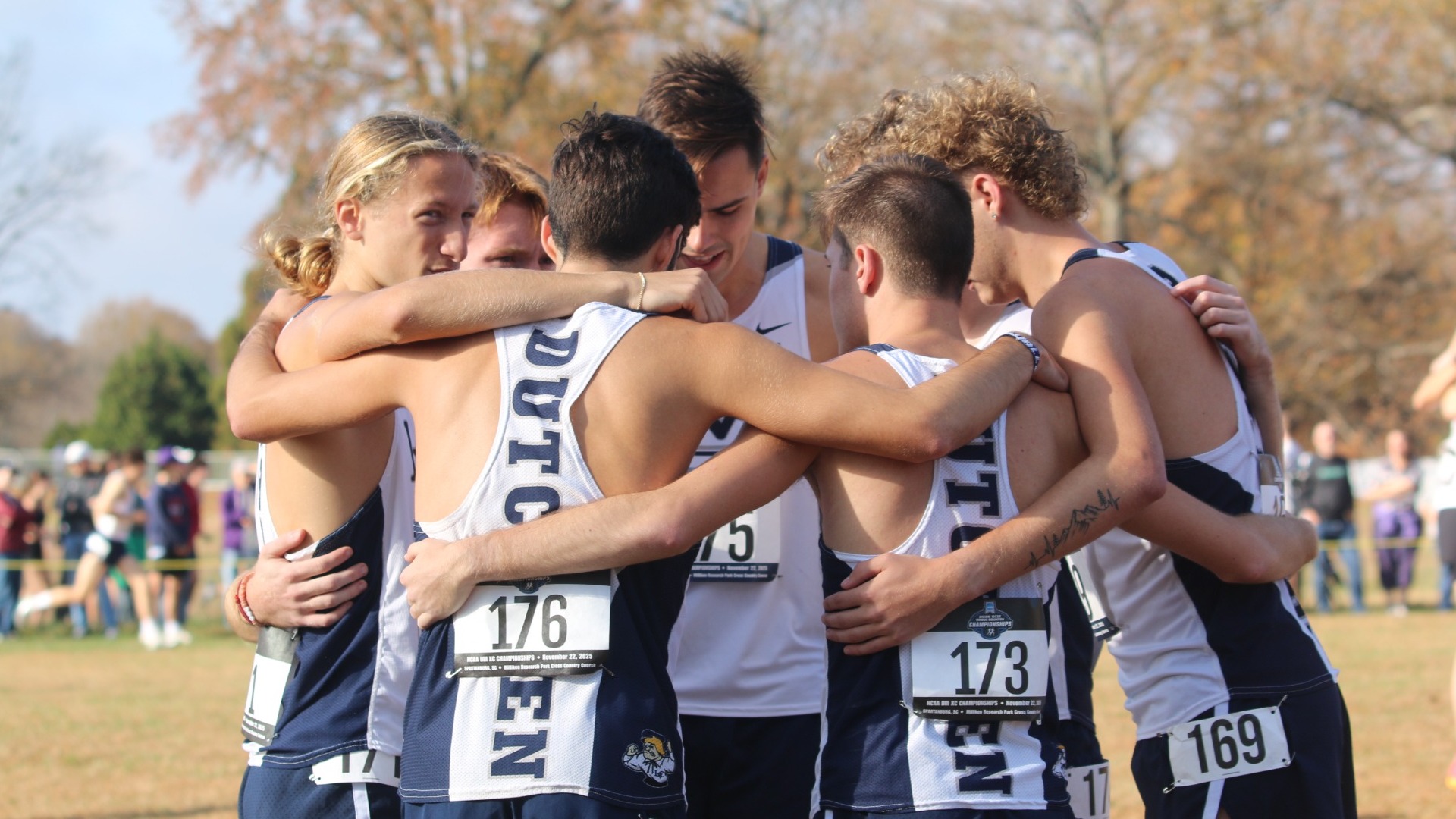 Men's Cross Country group huddle at nationals