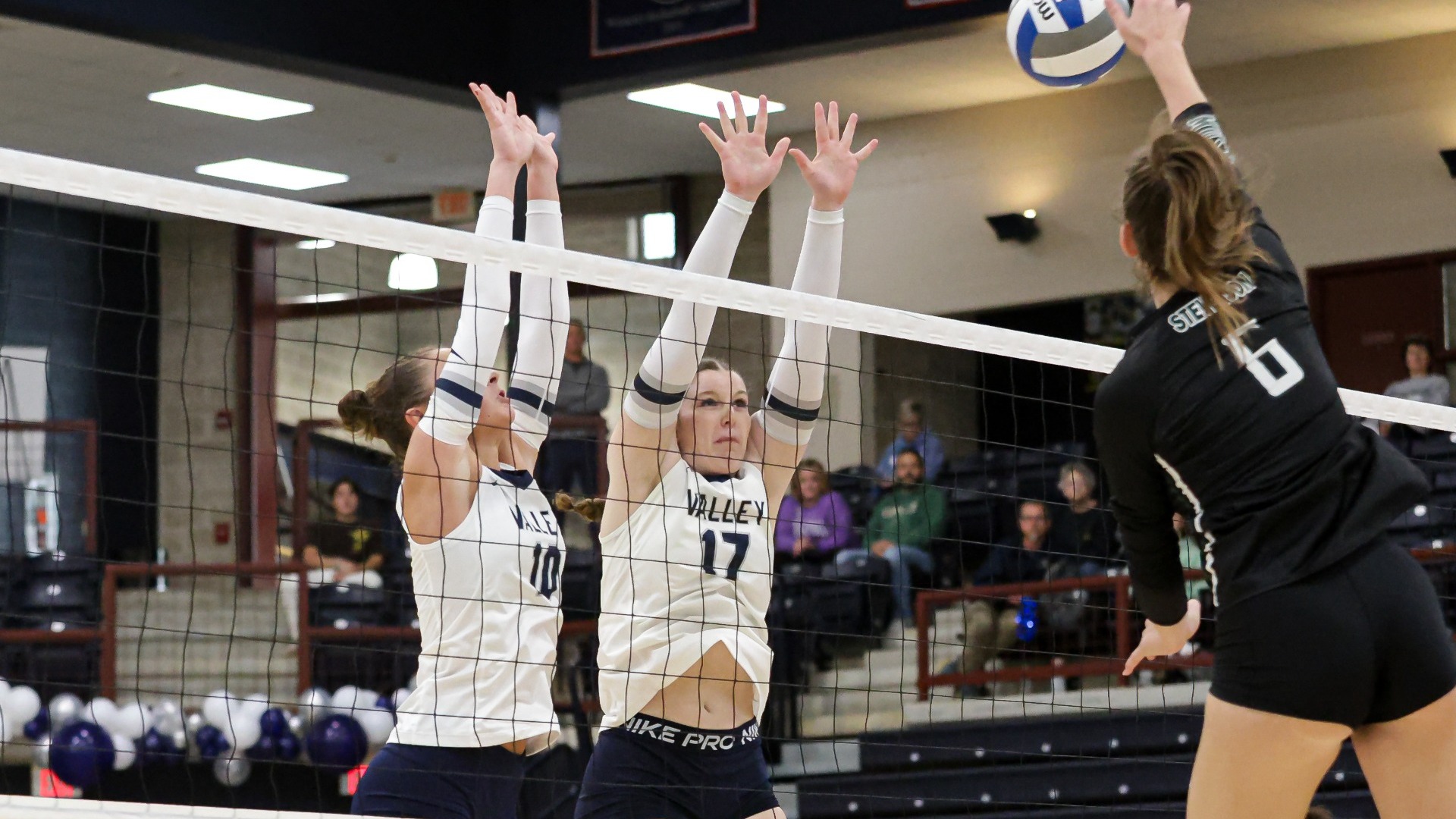 Cole and Rios going up for a block