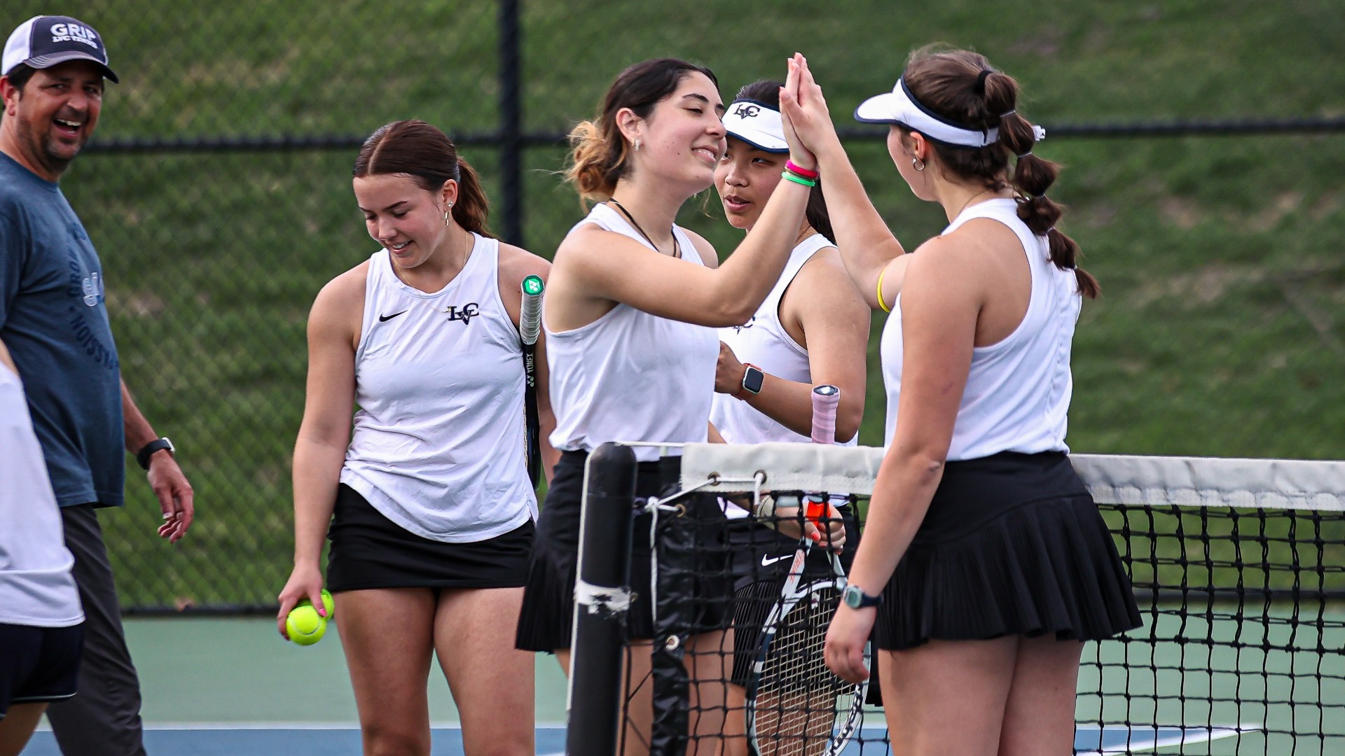 Women's tennis celebrating match victory