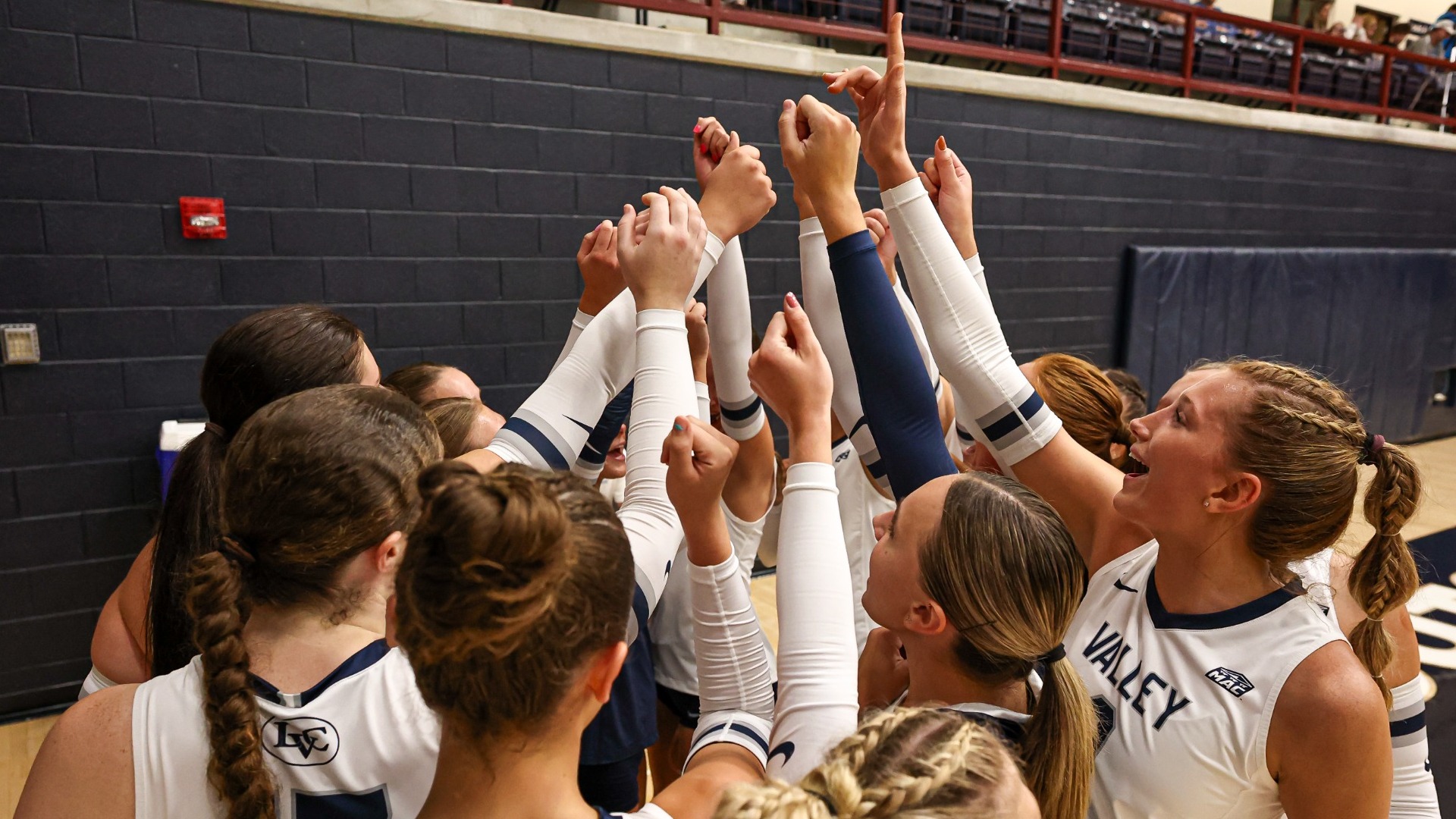 Volleyball team group huddle prior to match