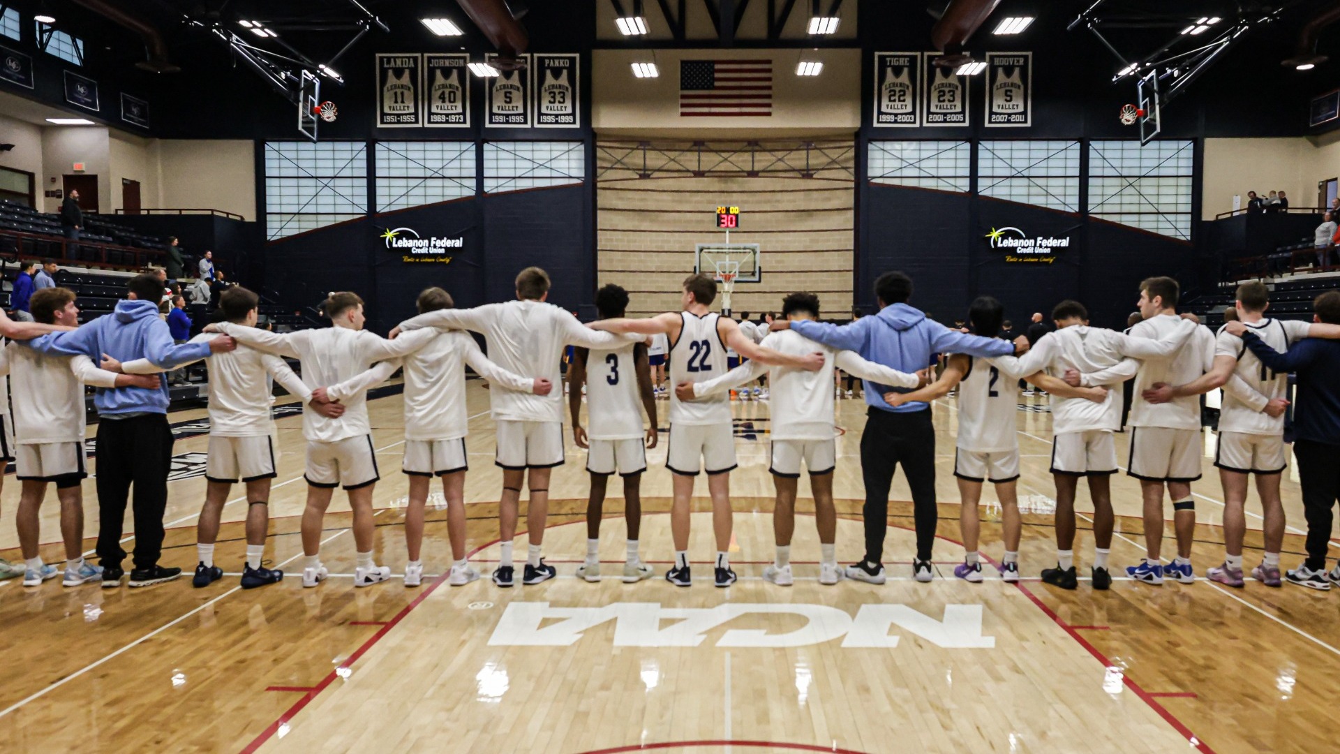 2025-26 men's basketball team lined up for anthem