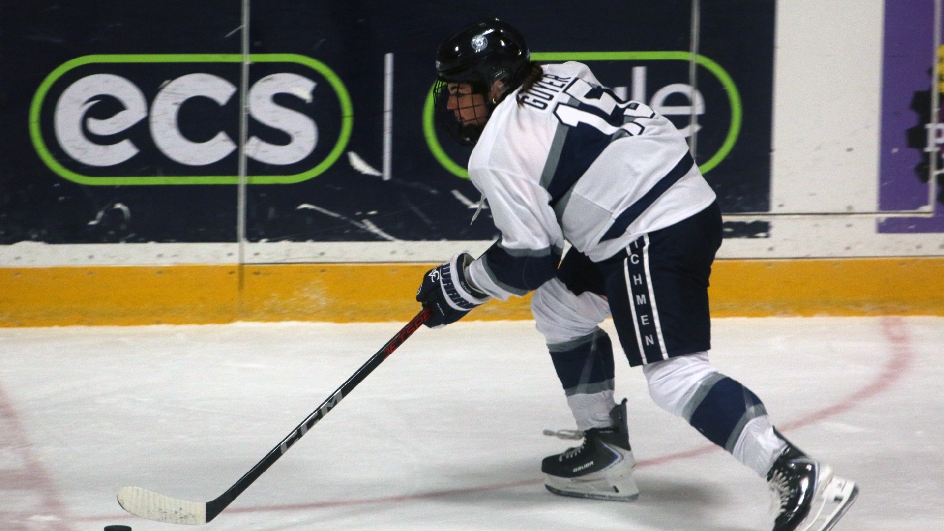 Allison Guyer racing puck down the ice