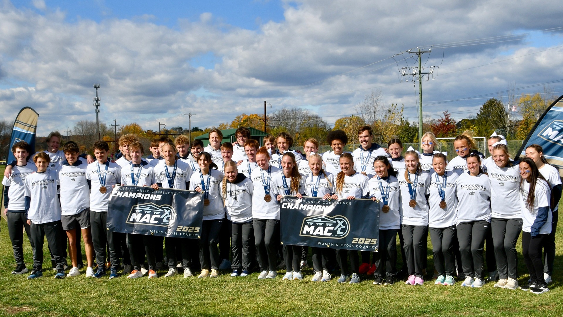 cross country teams with banners at MAC Championships 2025