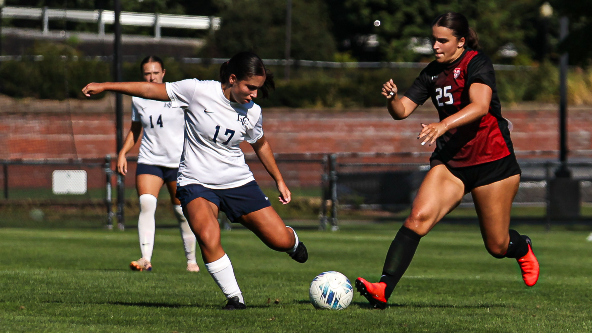 Mikhaela Sartor battles with a defender for the ball