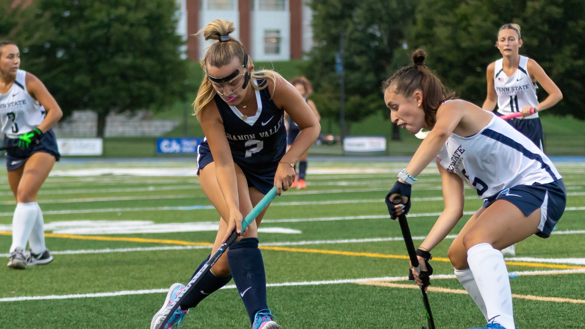 Maggie McAteer dribbling by defenders