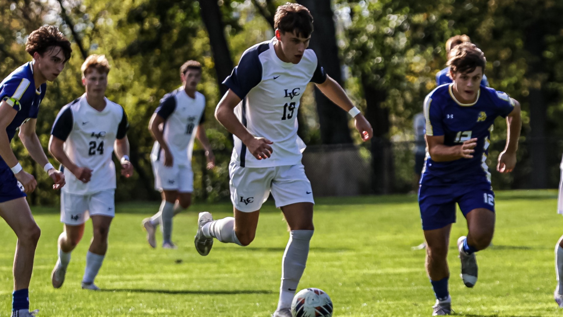 Will Burton takes the ball toward the net