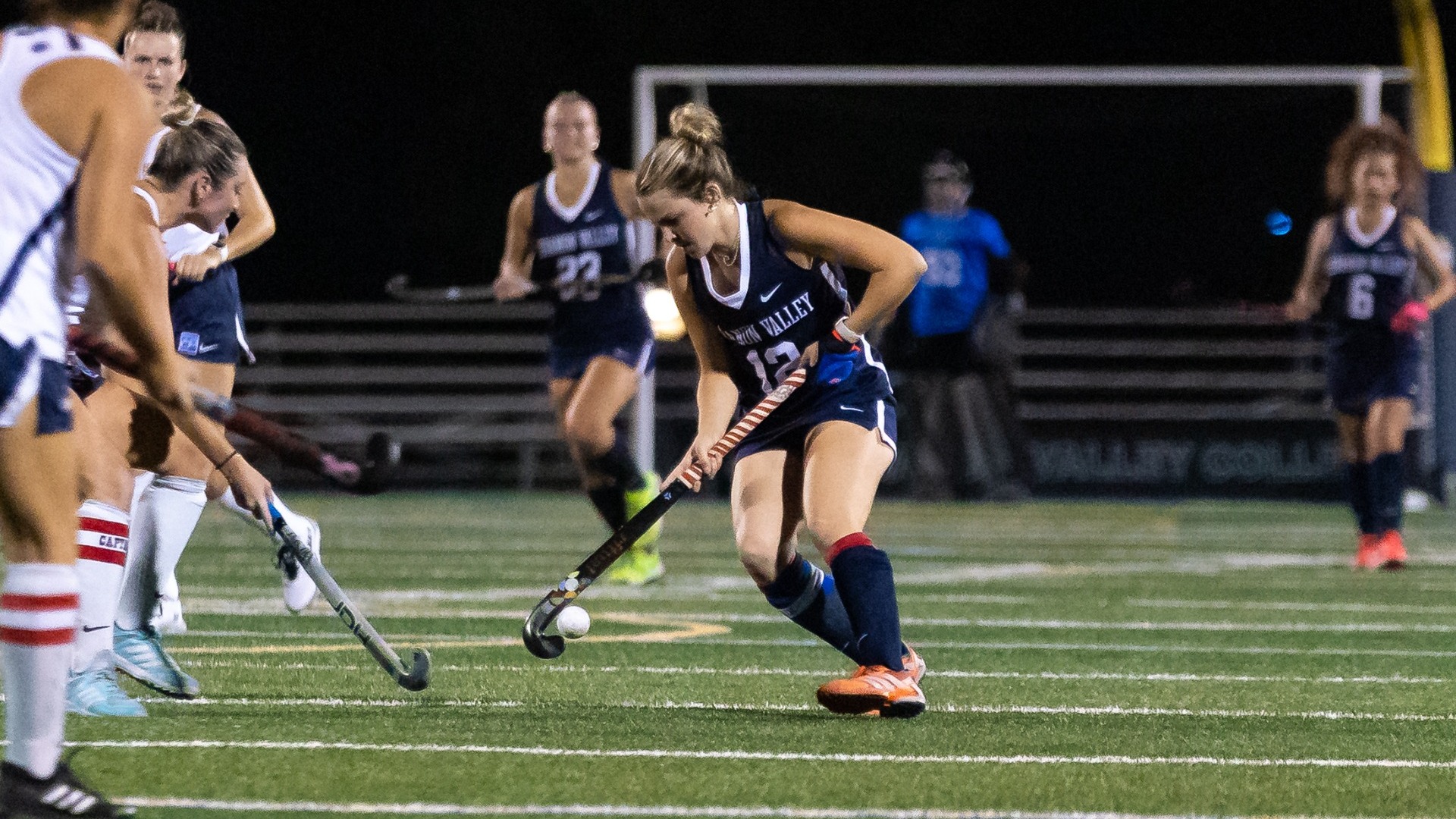 Claire Weidenhammer dribbling around defenders
