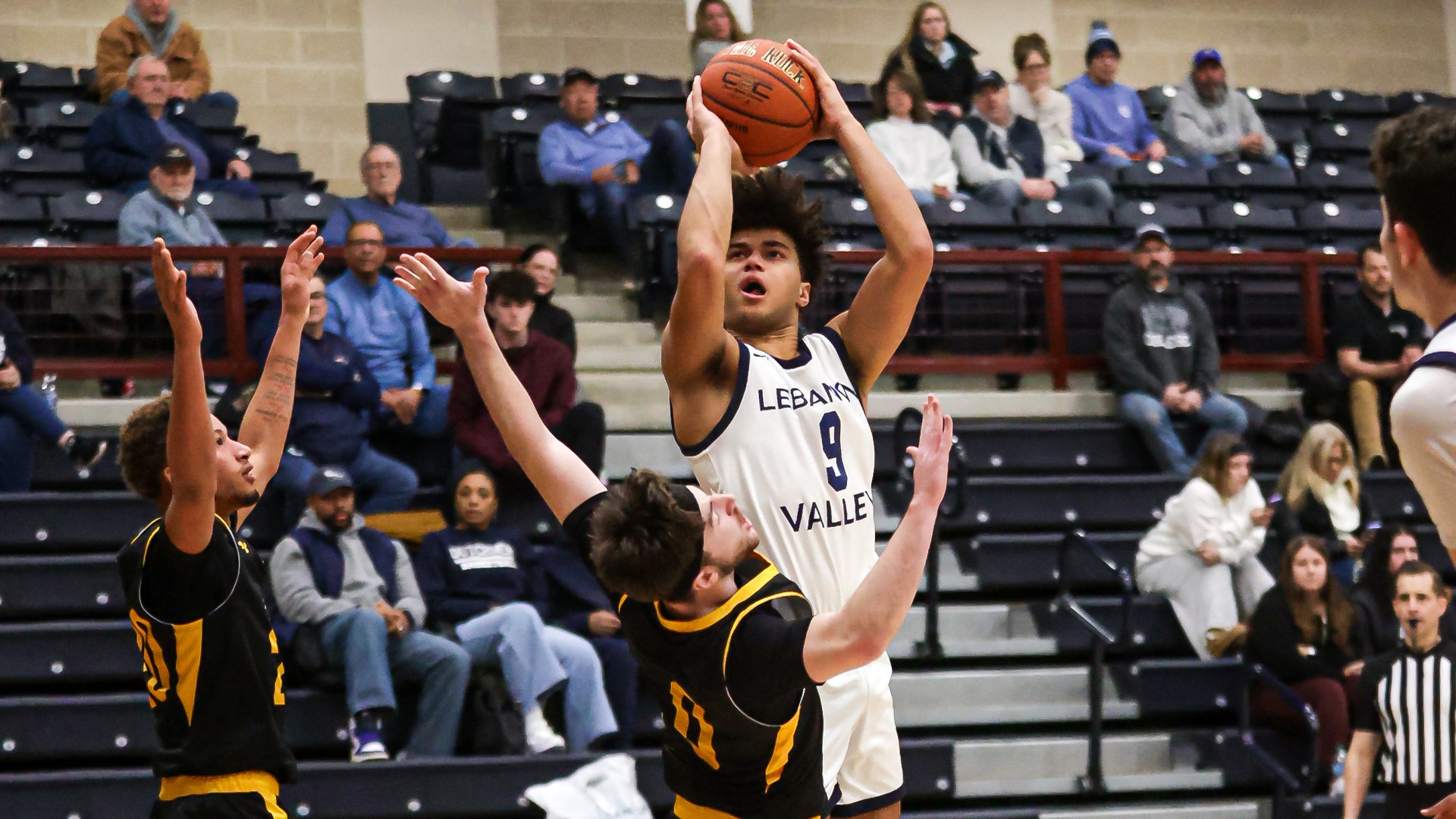 Giovanni Sejuste rising above defender for shot