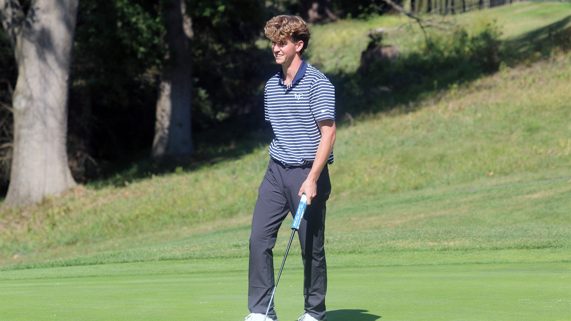 Reagan Flynn smiling after making putt