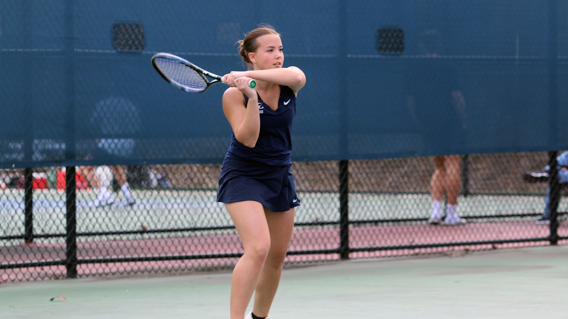 Sarah McComas watching backhand return shot