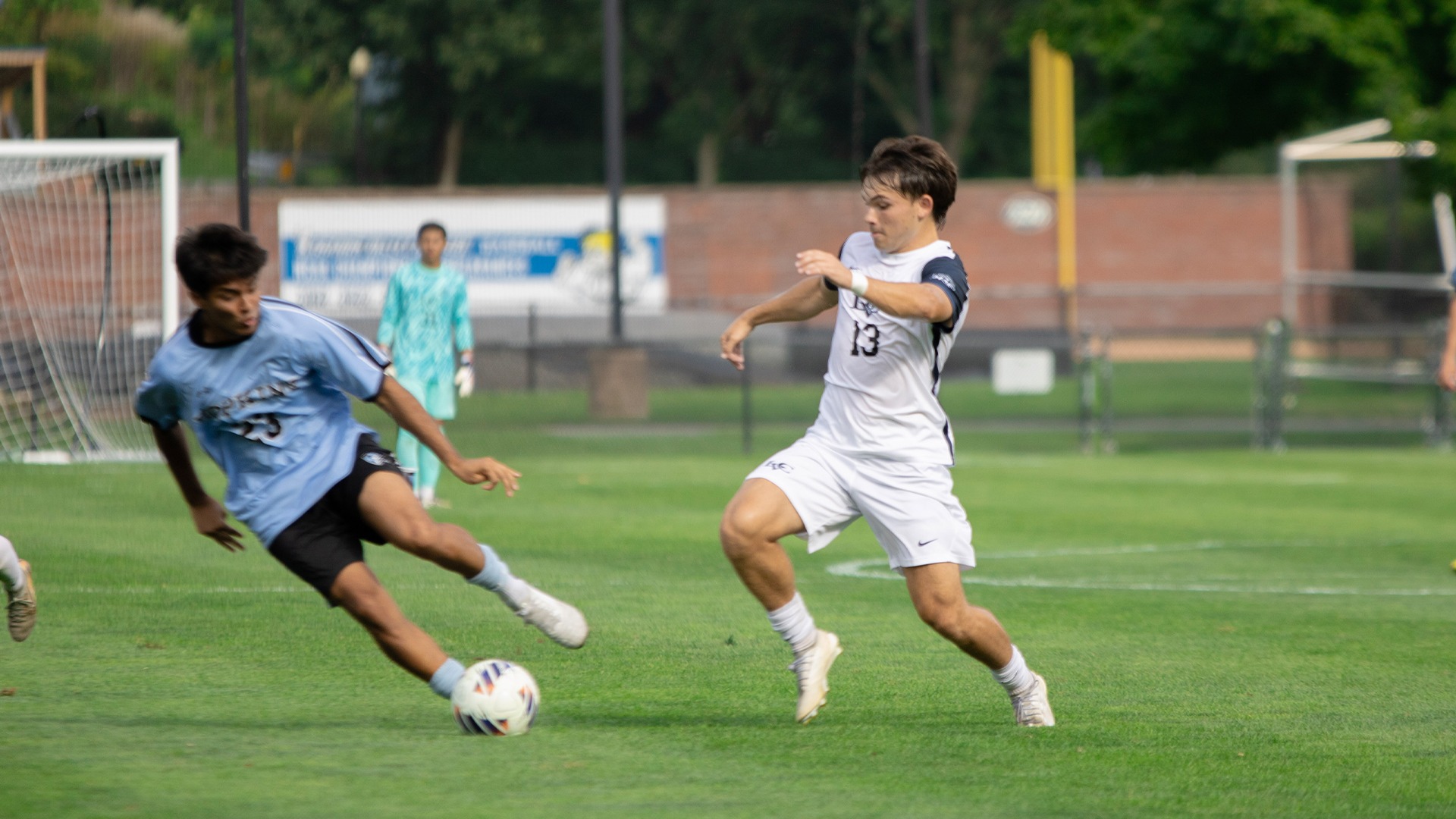 Ollie Lynch passing past defender