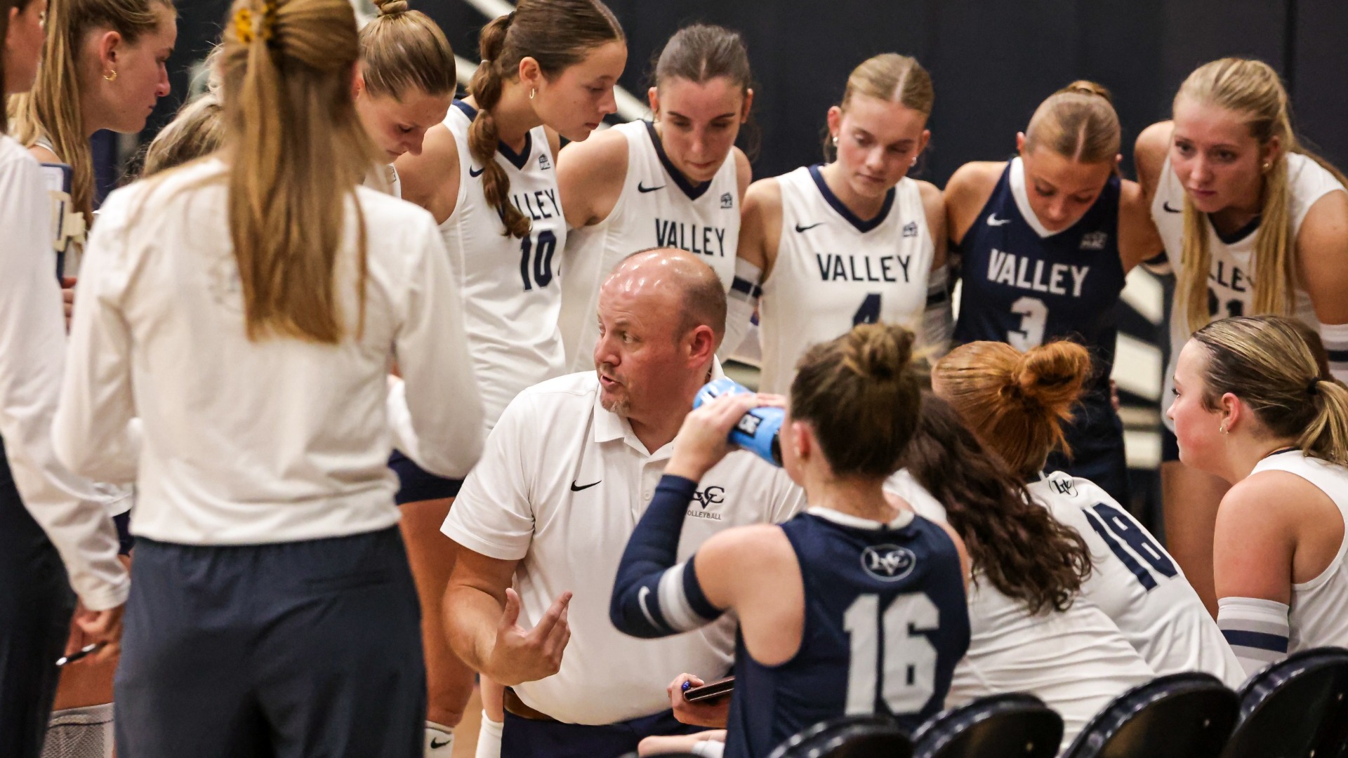 Women's Volleyball team huddle during timeout