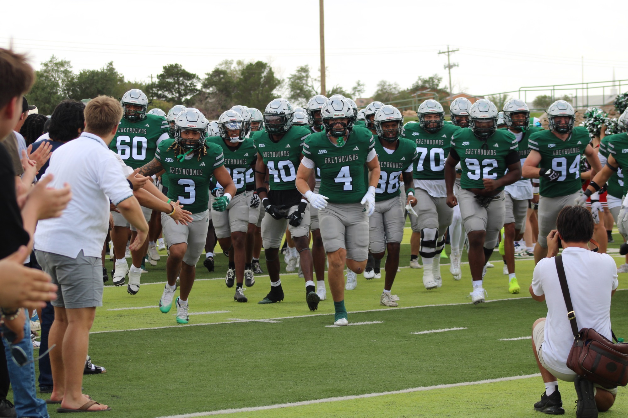 The Greyhounds running through the student tunnel