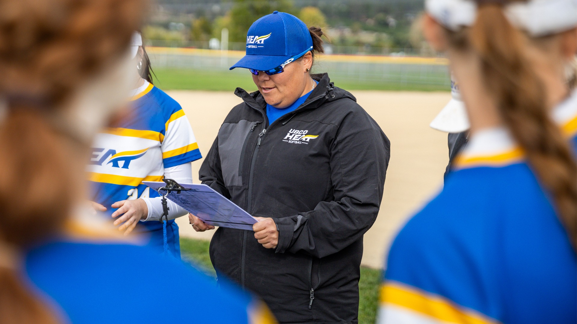 UBCO softball head coach Michelle Webster reads out the starting lineup prior to the Heat's game against Victoria at High Noon Park.