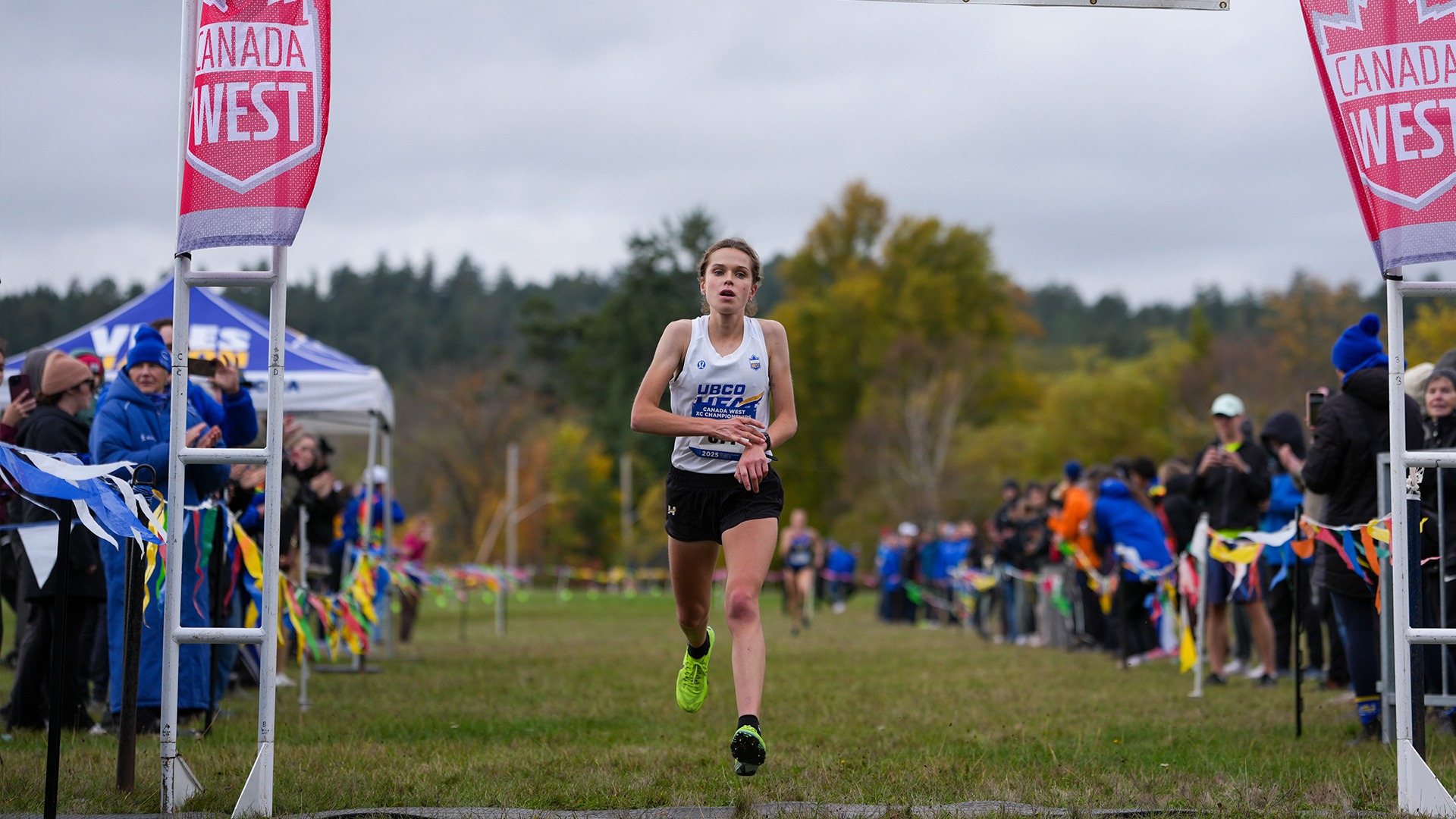 UBCO cross country runner Lauren McNeil crosses the finish line in first place to win gold at the 2025 Canada West Championships in Victoria.