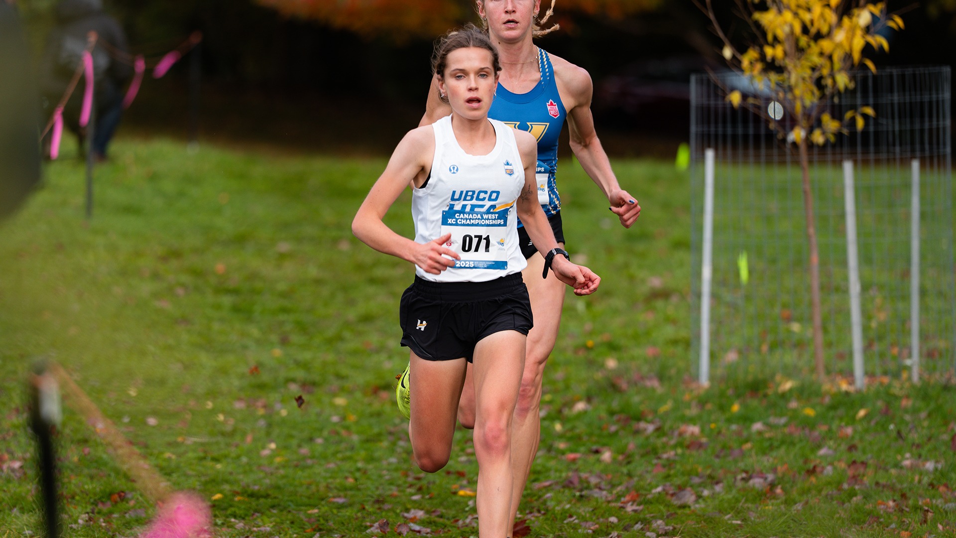UBCO cross country runner Lauren McNeil runs in front of Victoria's Madelyn Eybergen during action at the 2025 Canada West Championships in Victoria.