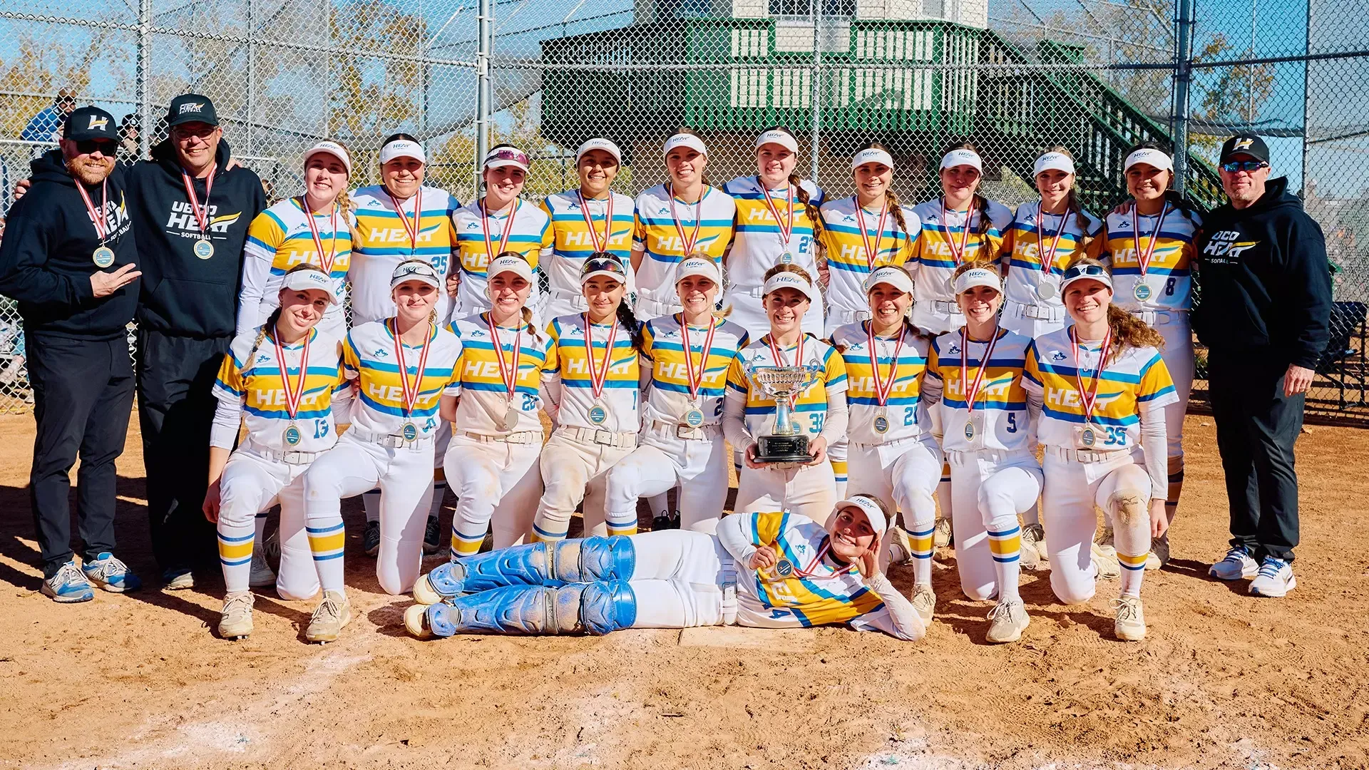 The UBCO Heat softball teams poses with the championship trophy following their 6-0 win over the Calgary Dinos in the 2025 WCSA Championship game.