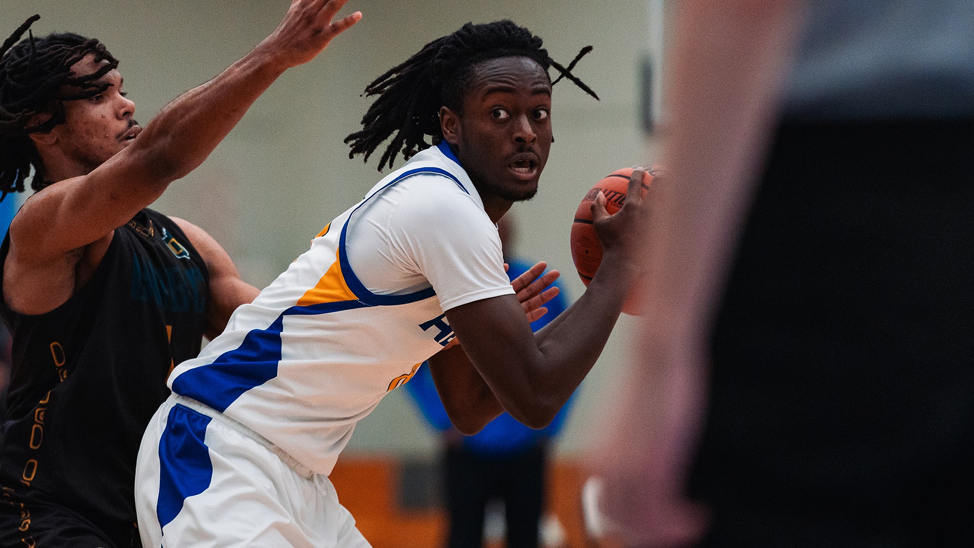 UBCO guard Mike Adarkwah-Nti shields off his defender during action against the UNBC Timberwolves at the UBCO Gymnasium.