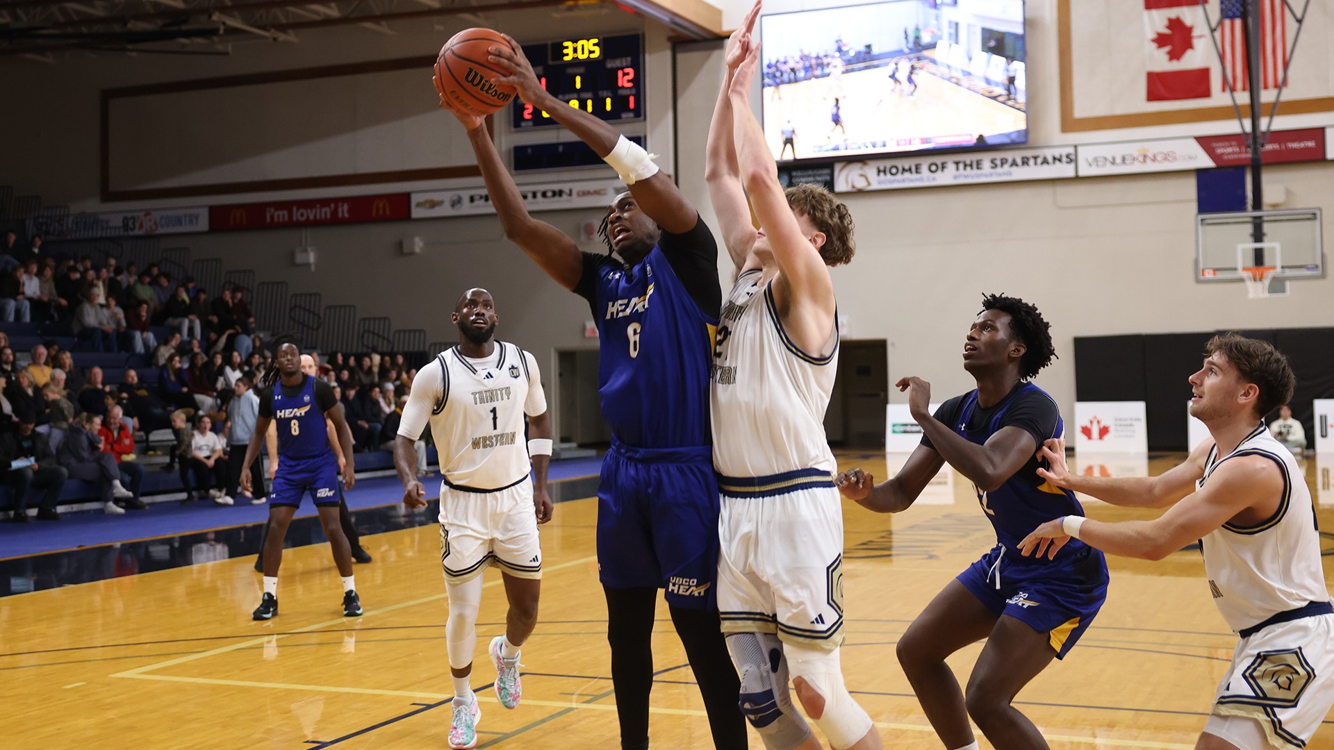 UBCO forward Wisdom Sunday battles for a rebound during action against the Trinity Western Spartans in Langley.