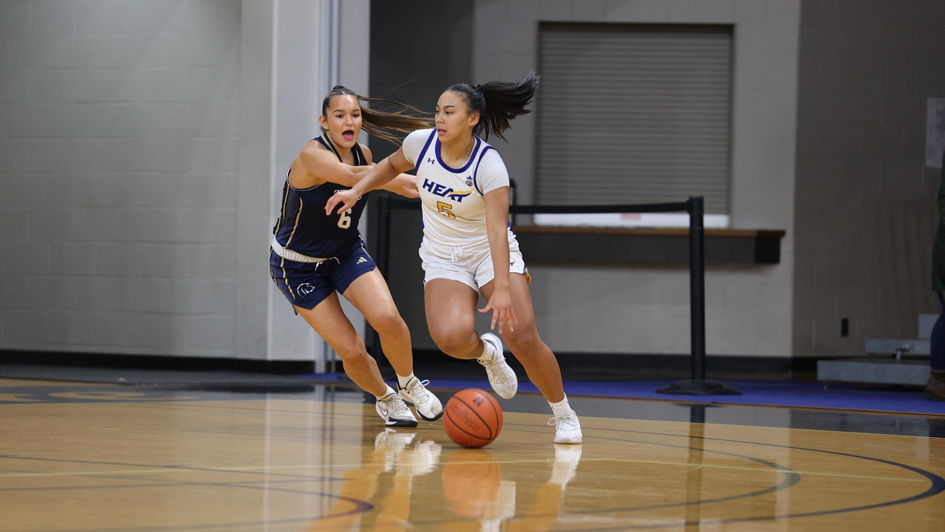 UBCO guard Aiko Williams dribbles past her defender during action against the Trinity Western Spartans in Langley.