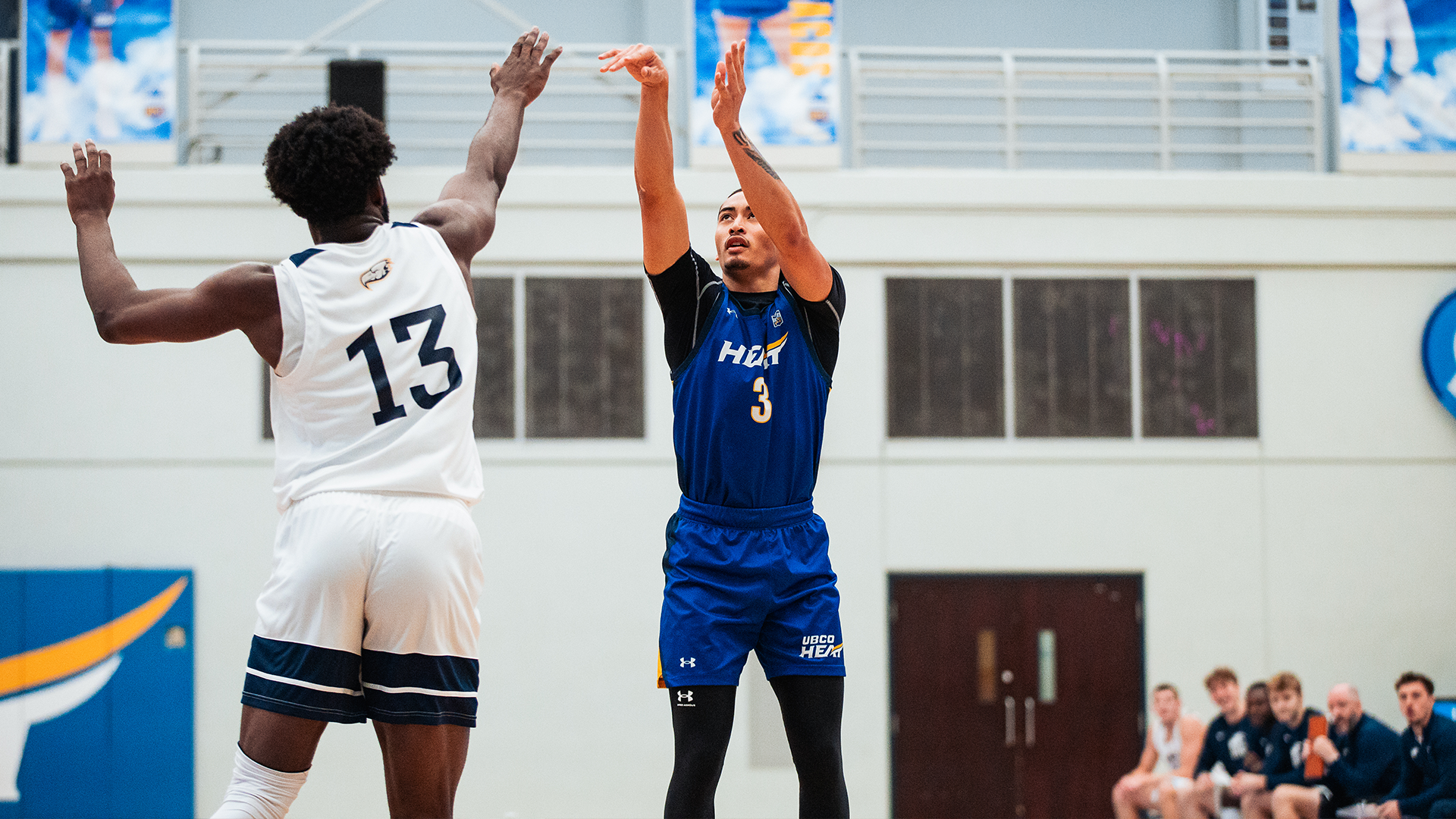 UBCO guard Isaak Moore launches a 3-point shot during action against the UBC Thunderbirds at the UBCO Gymnasium.