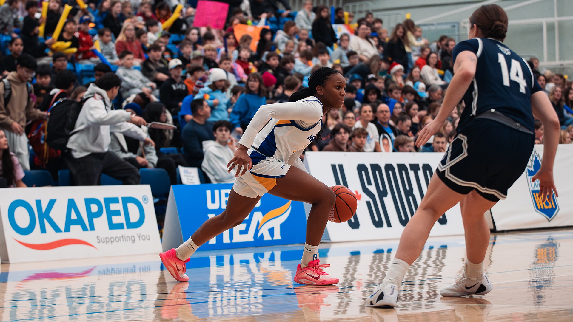 UBCO guard Temi Aina drives to the lane during the Heat's School Day Game against the Mount Royal Cougars at the UBCO Gymnasium.