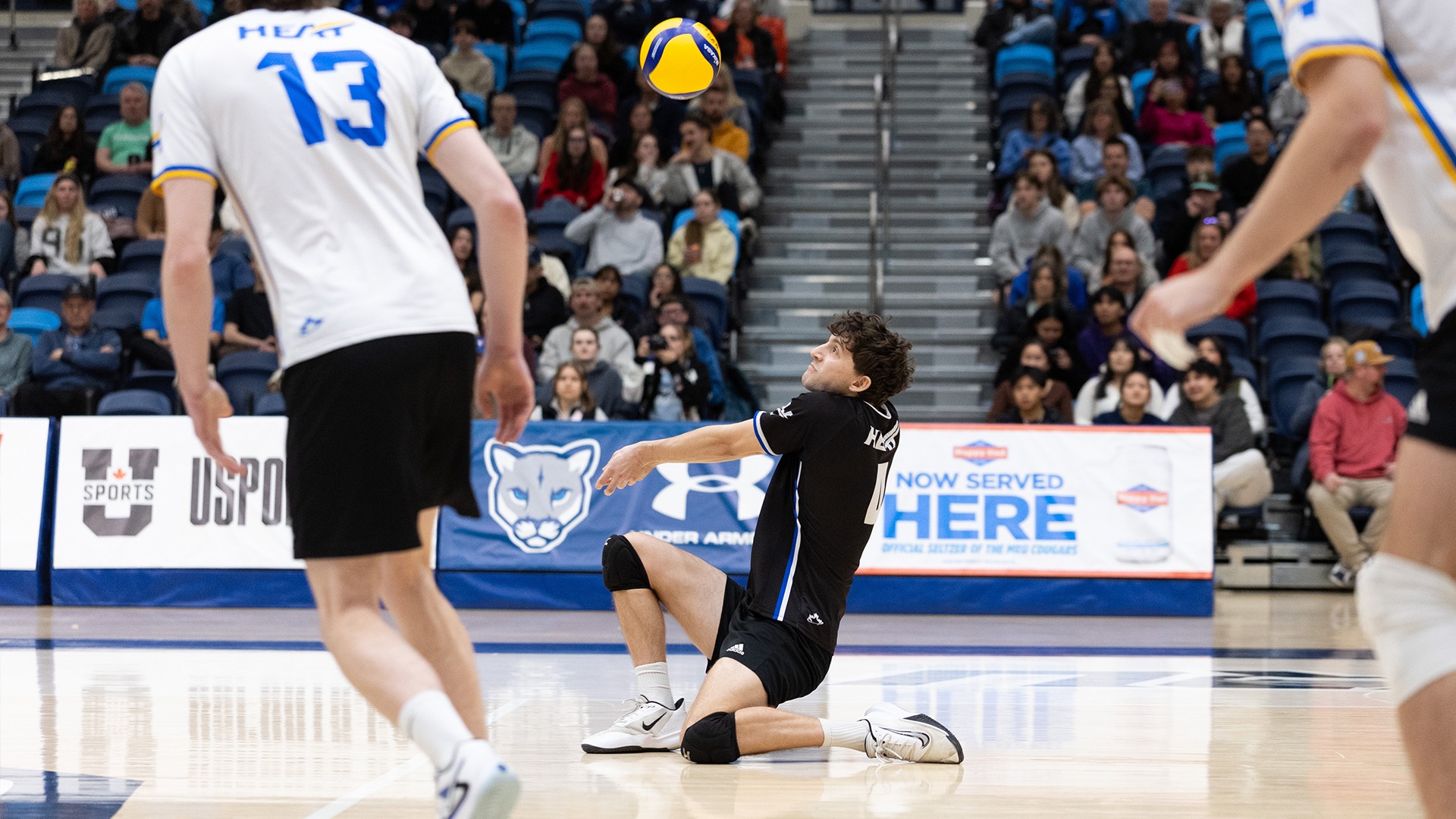 UBCO libero Maxim Storozhuk digs a ball during action against the Mount Royal Cougars in Calgary.