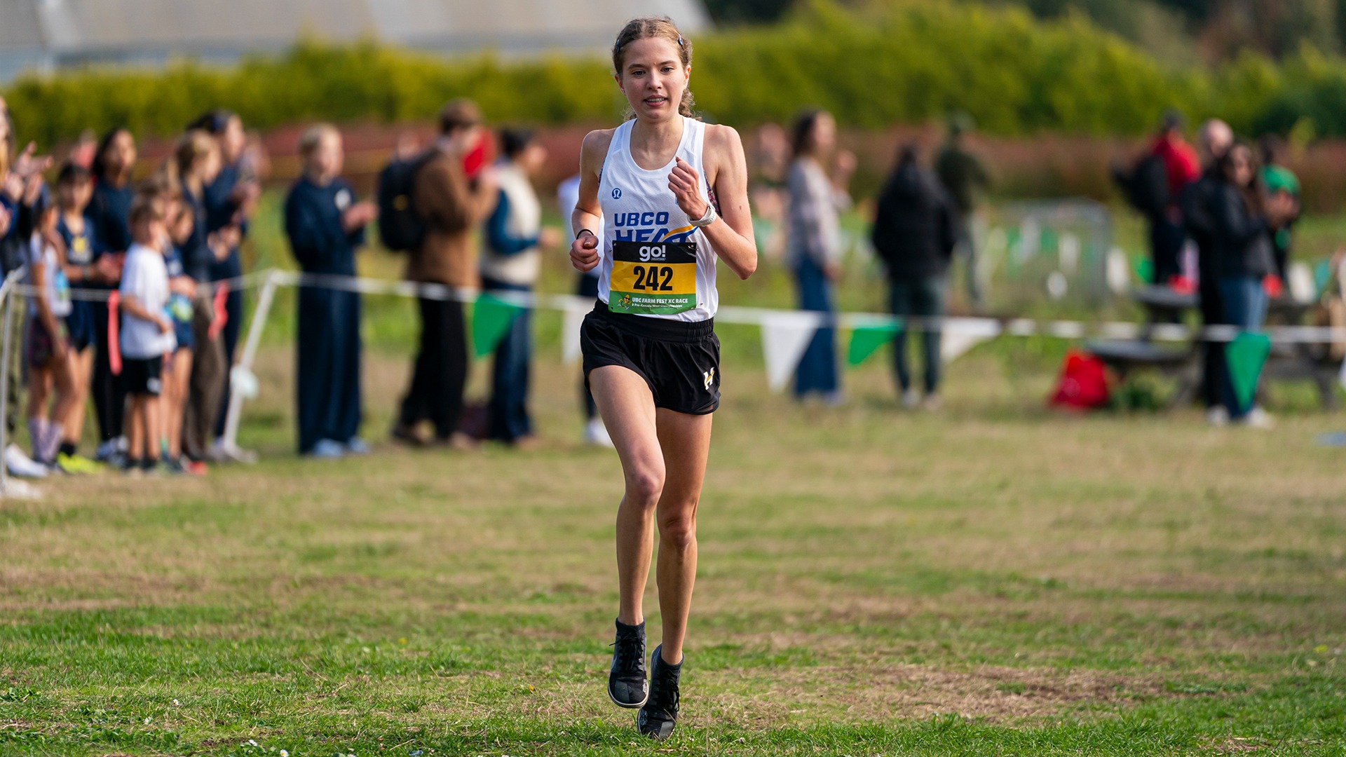 Abigail Yakemchuk running to the finish line at the UBC Farm Fest
