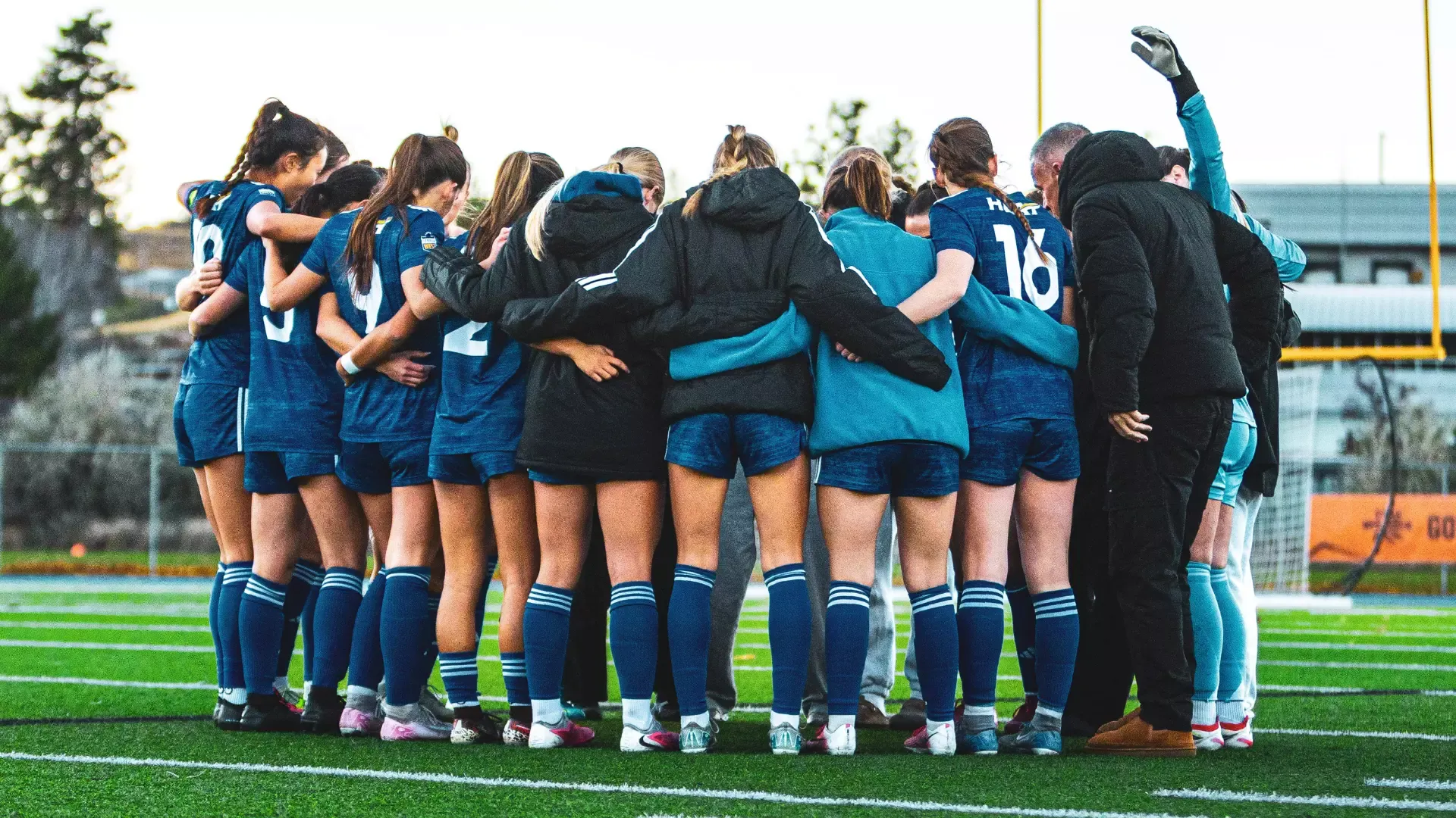UBCO Heat Womens Soccer team forms a group huddle in game vs TRU Wolfpack