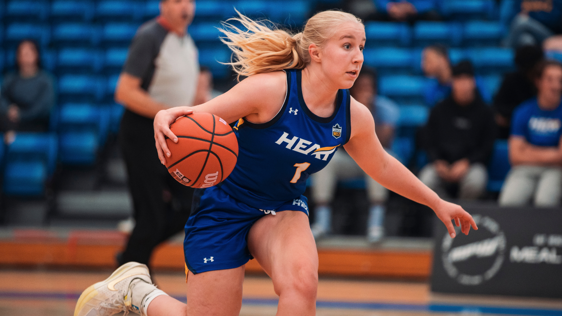Kiana Kaczur of the UBCO womens basketaball team dribbles the ball up the court, stock