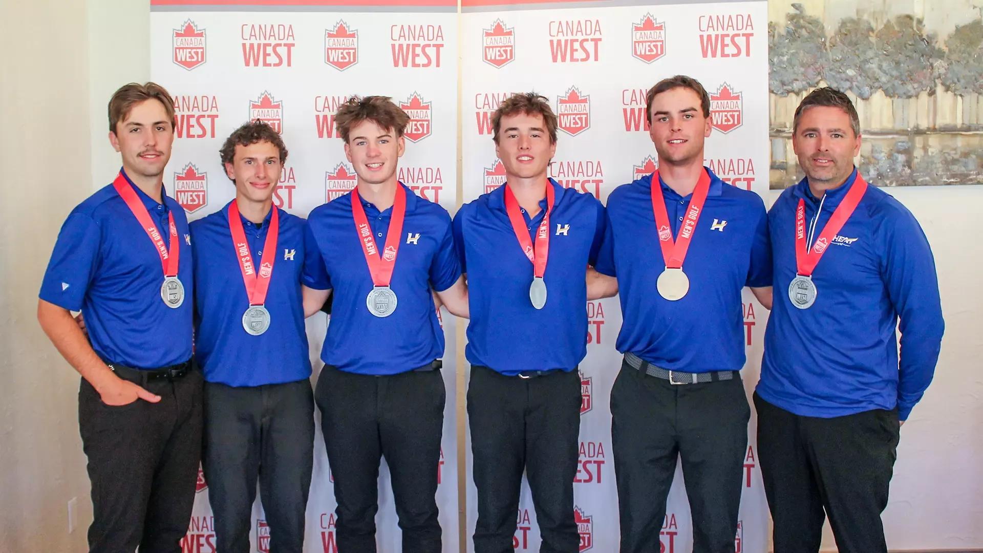 The men's golf team smiles with their silver medals at the 2026 Canada West Championships in Lethbridge, Alta.