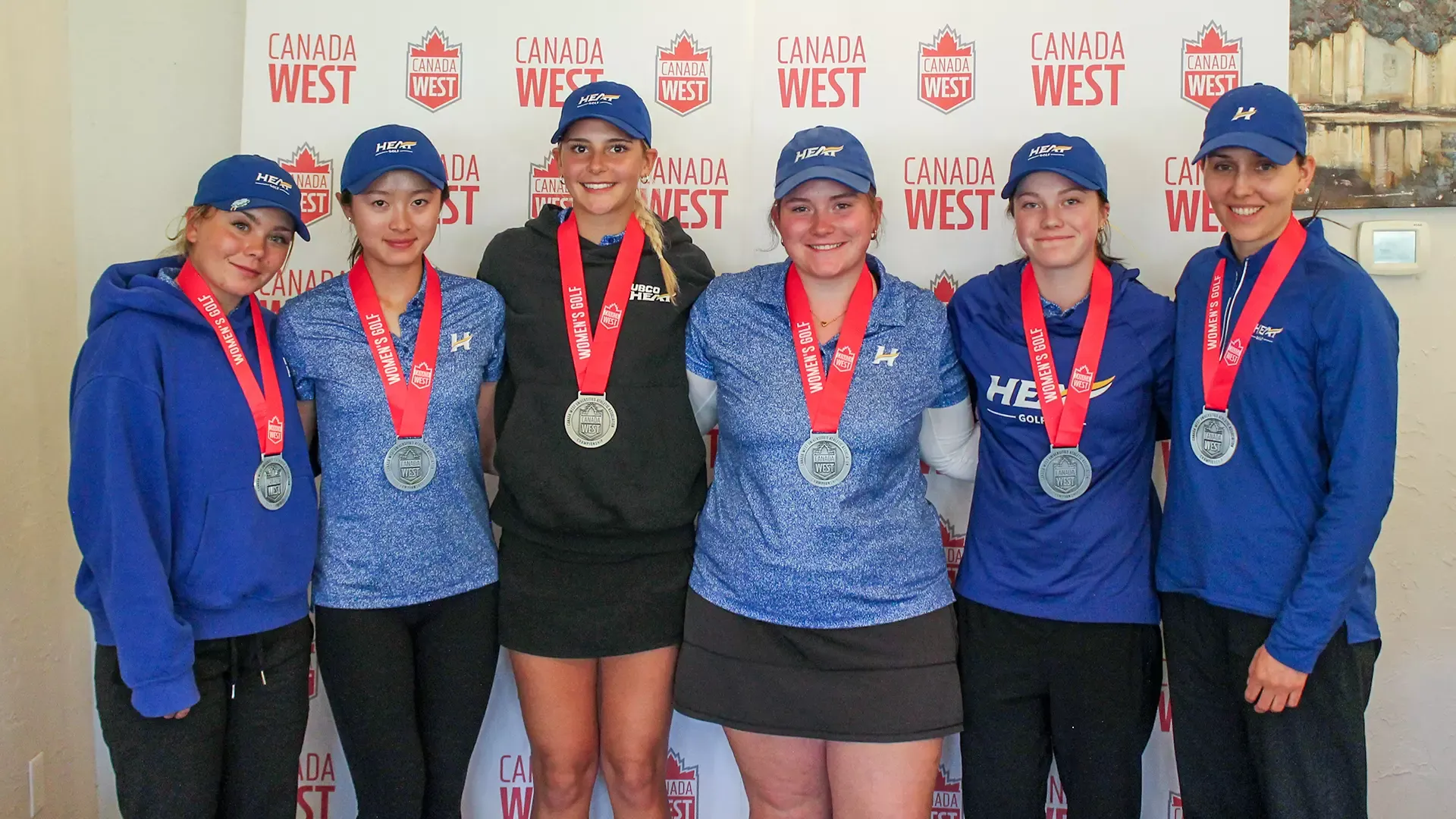 The women's golf team smiles with their silver medals at the 2026 Canada West Championships in Lethbridge, Alta.