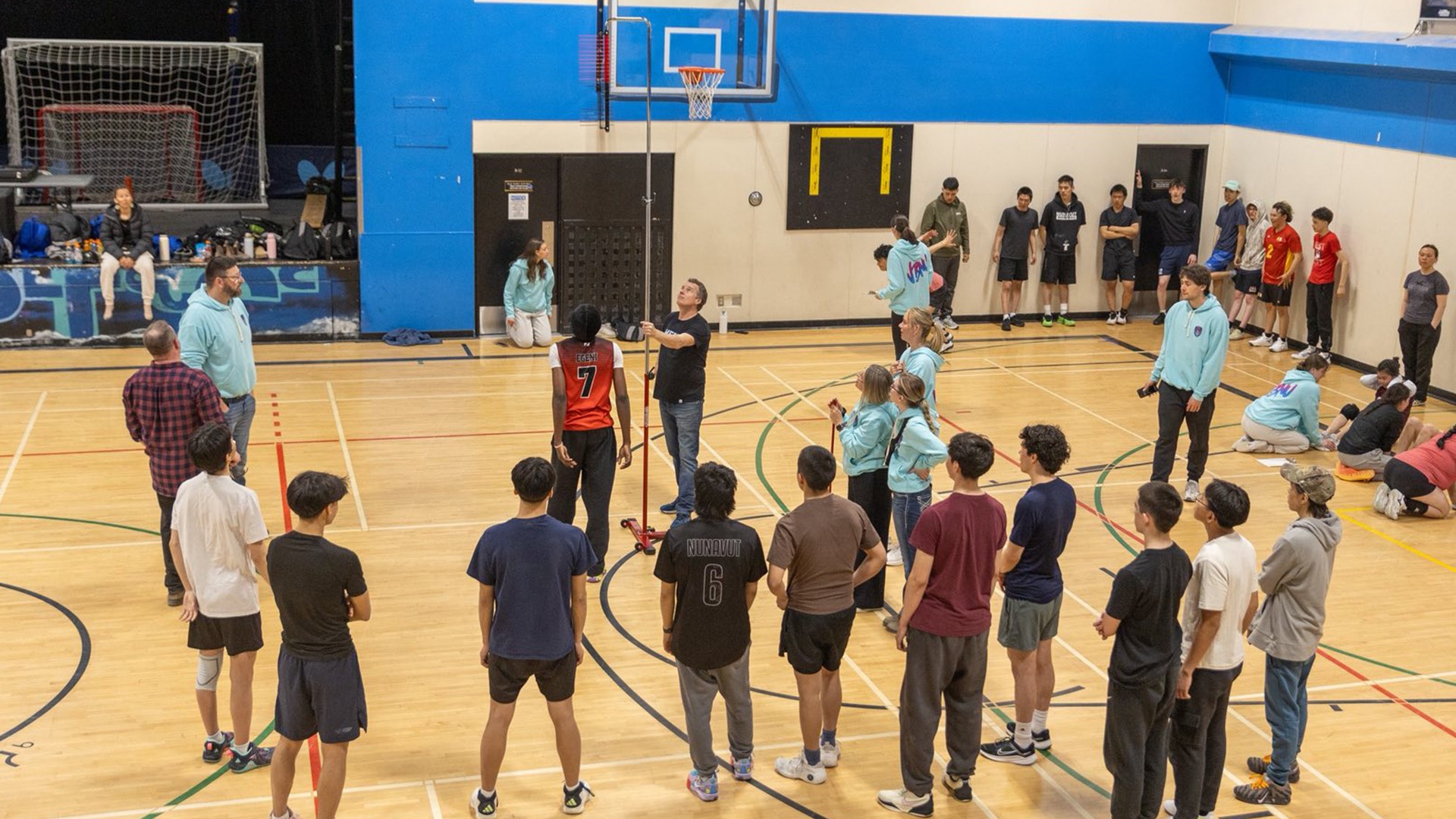 Members of the UBCO Heat volleyball teams, wearing teal sweaters, assist with various elements of combine testing during their trip to Iqaluit in May.