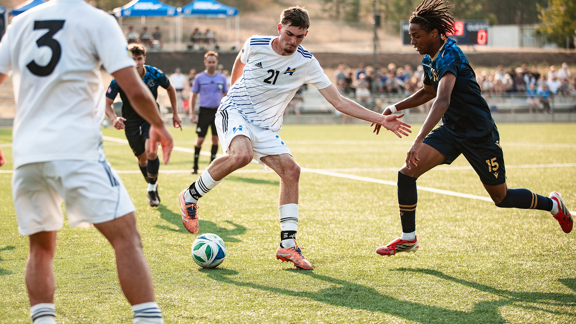 UBCO forward Mosi Klusman turns against a Trinity Western defender during action against the Spartans at Nonis Spors Field.