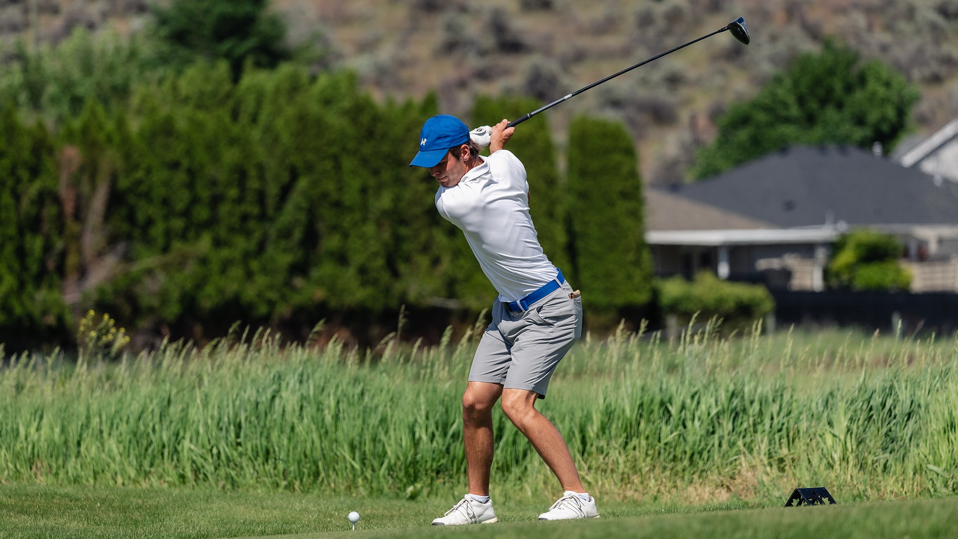 Ryan Gillis, a UBCO men's golfer, swinging a club at a UBCO qualification round in 2025.
