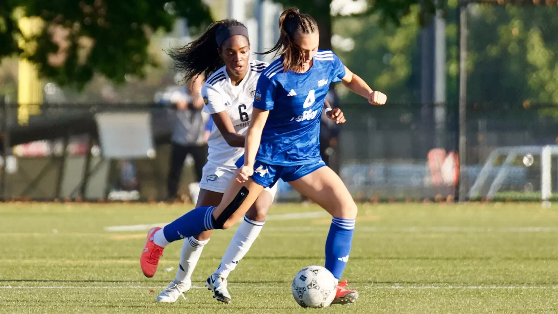 UBCO Womens soccer midfielder Katie Scarth battles for ball against UBC