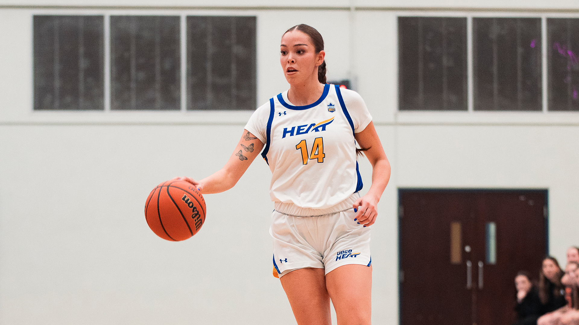 Kanani Coon, a UBCO women's basketball player, dribbles the ball in a Canada West game during the 2025-26 season.