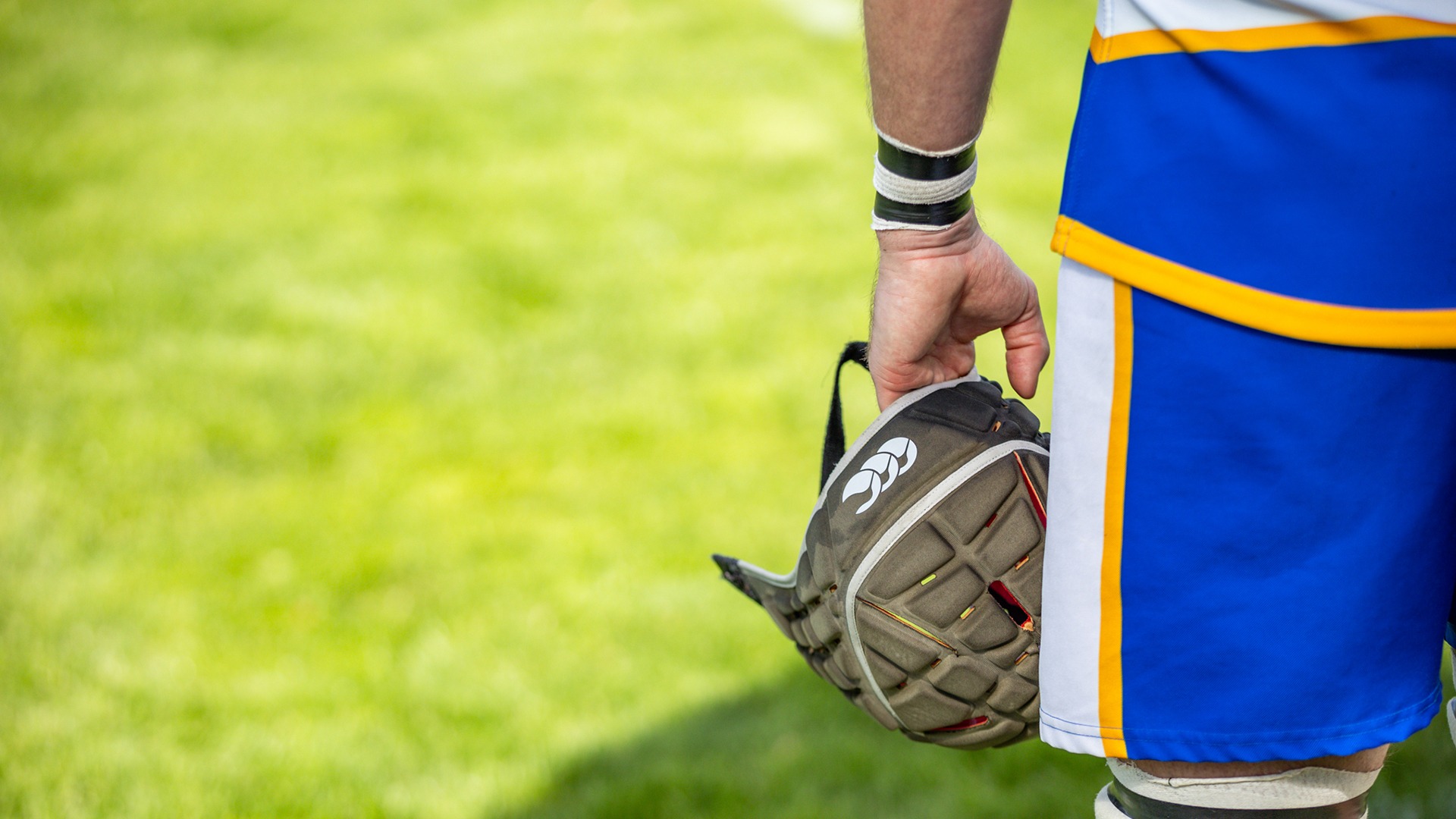 Men's rugby player holding his helmet in a game in 2024
