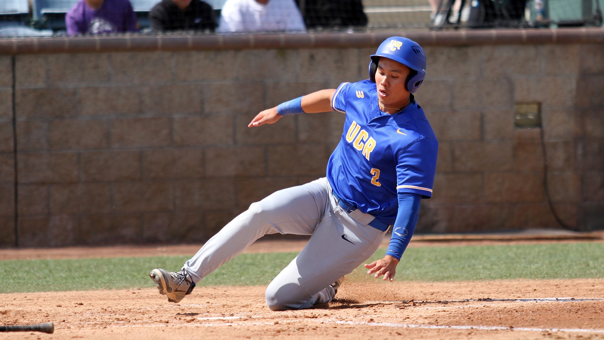 Andrew Rivas slides at home plate