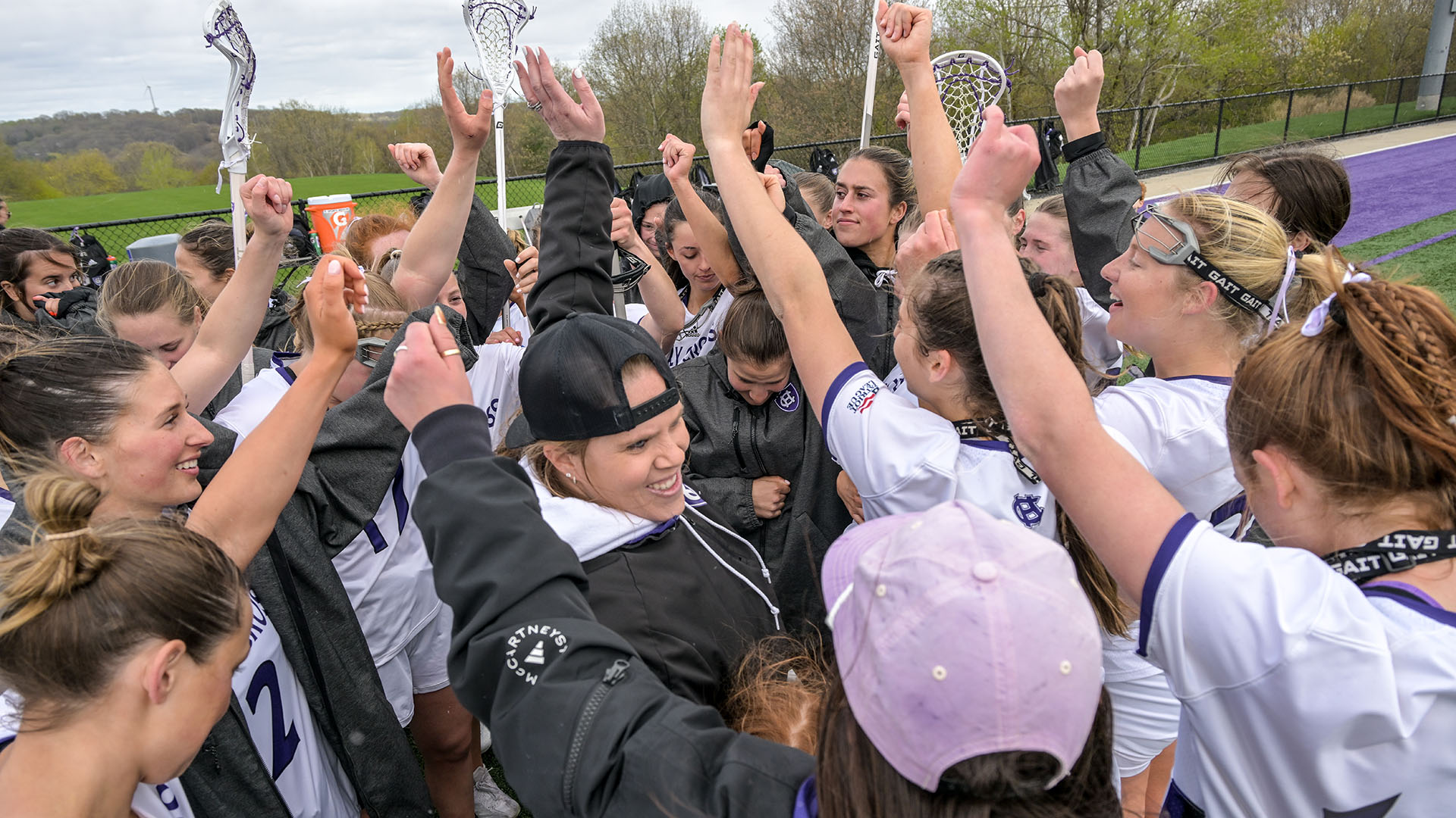 The women's lacrosse team celebrates following its victory over Colgate in the Patriot League Quarterfinals.